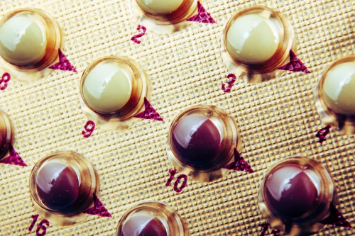 A close-up shot of a blister pack of contraceptive pills.
