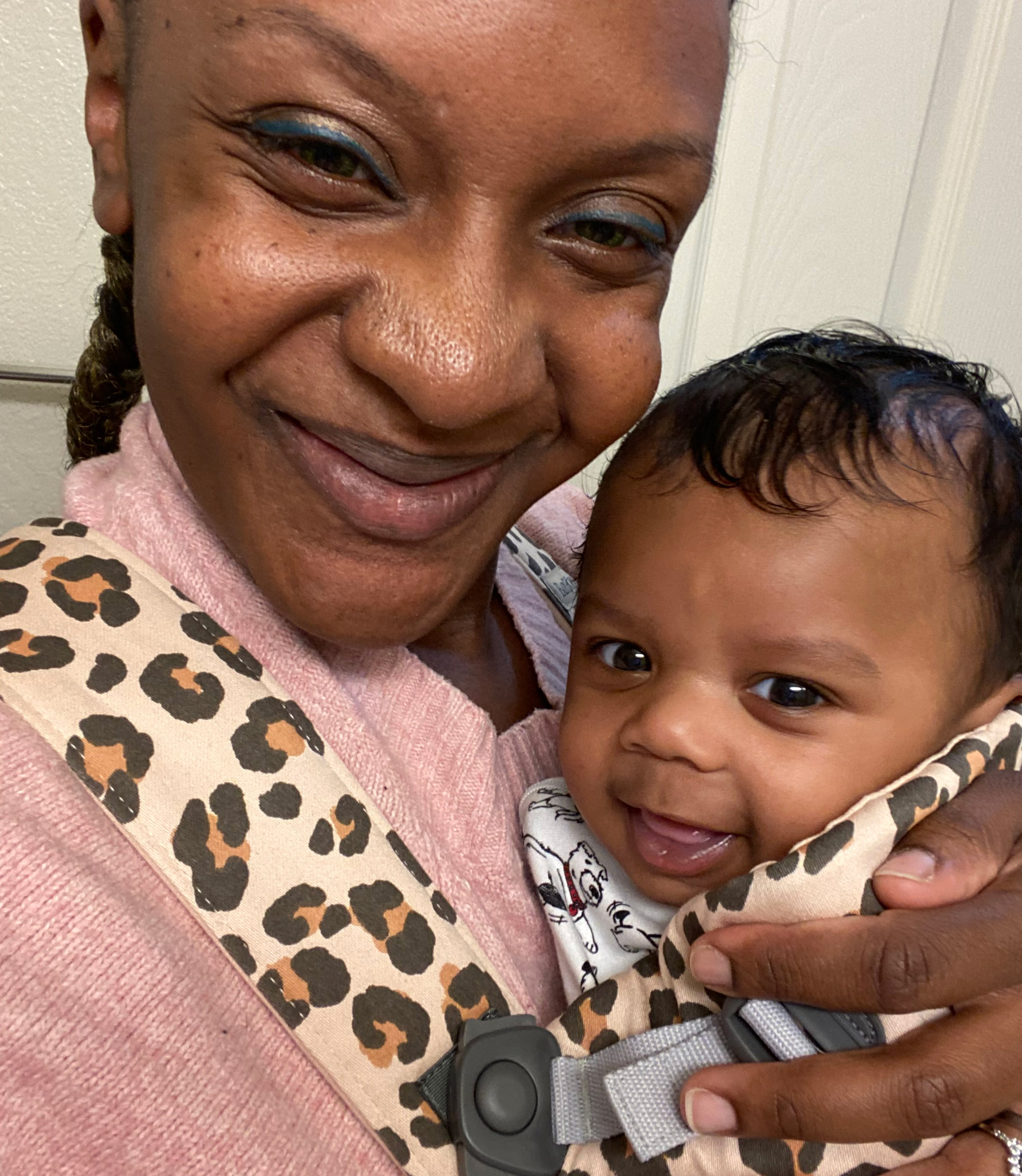 A photo of a Black woman holding her infant son.