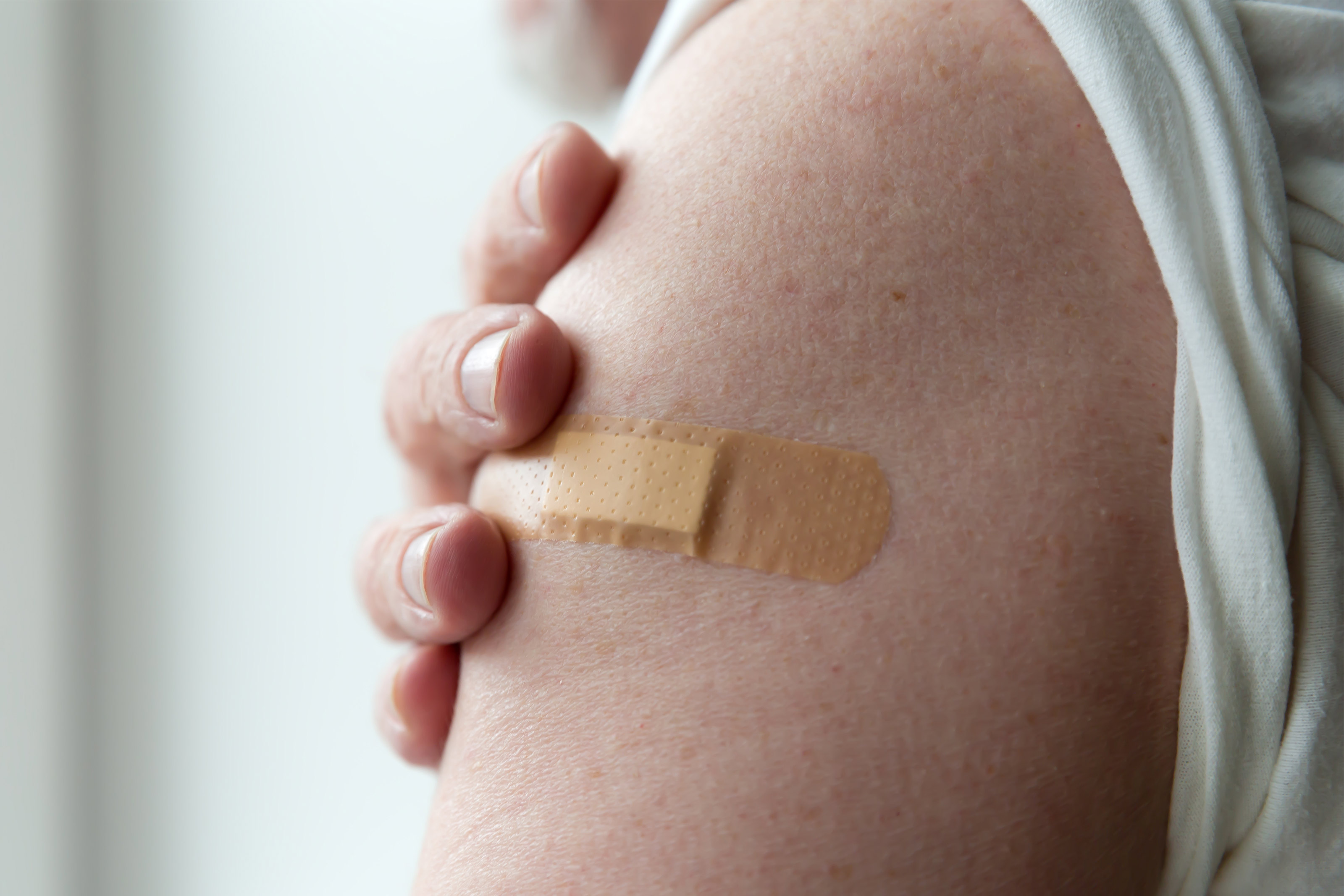 A photo of an arm bandaged after receiving a vaccine.