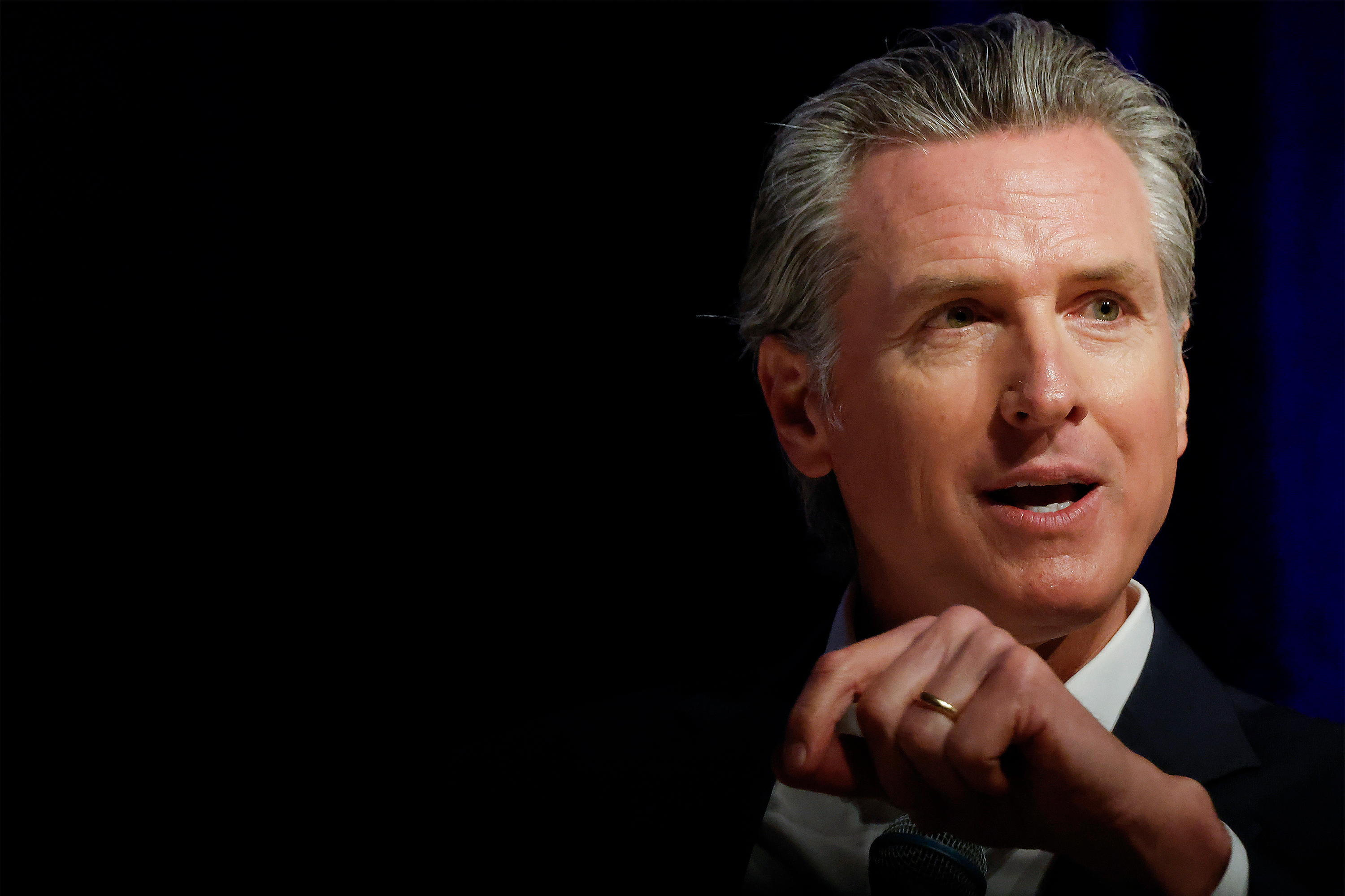 A photo of Gavin Newsom speaking before an audience.
