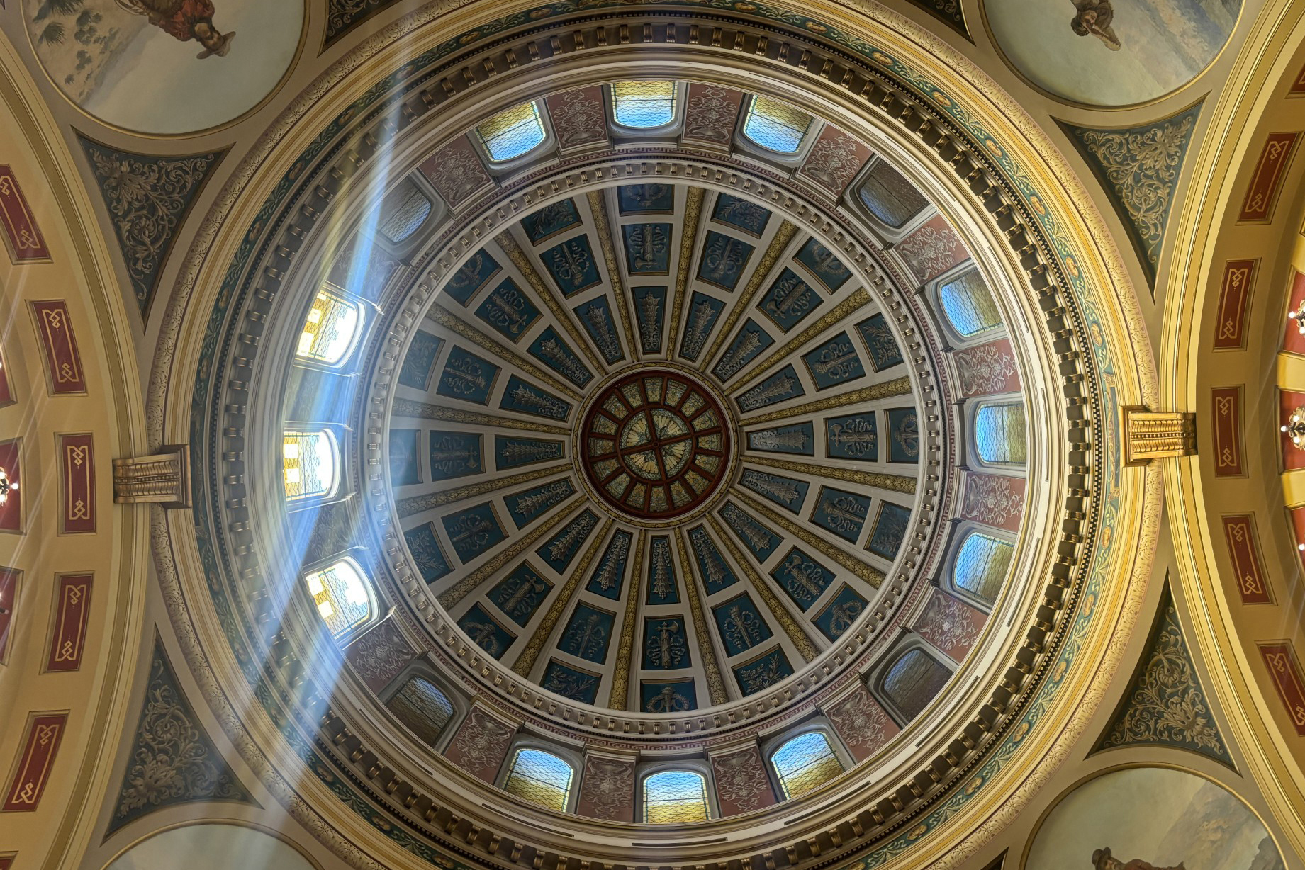 A photograph showing the ornate ceiling of the dome in the Montana Capitol.