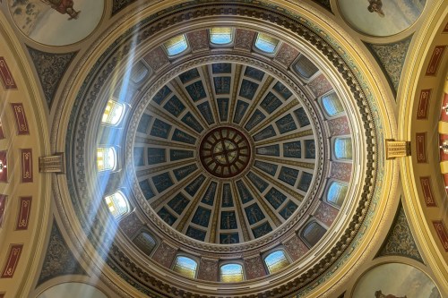 A photograph showing the ornate ceiling of the dome in the Montana Capitol.