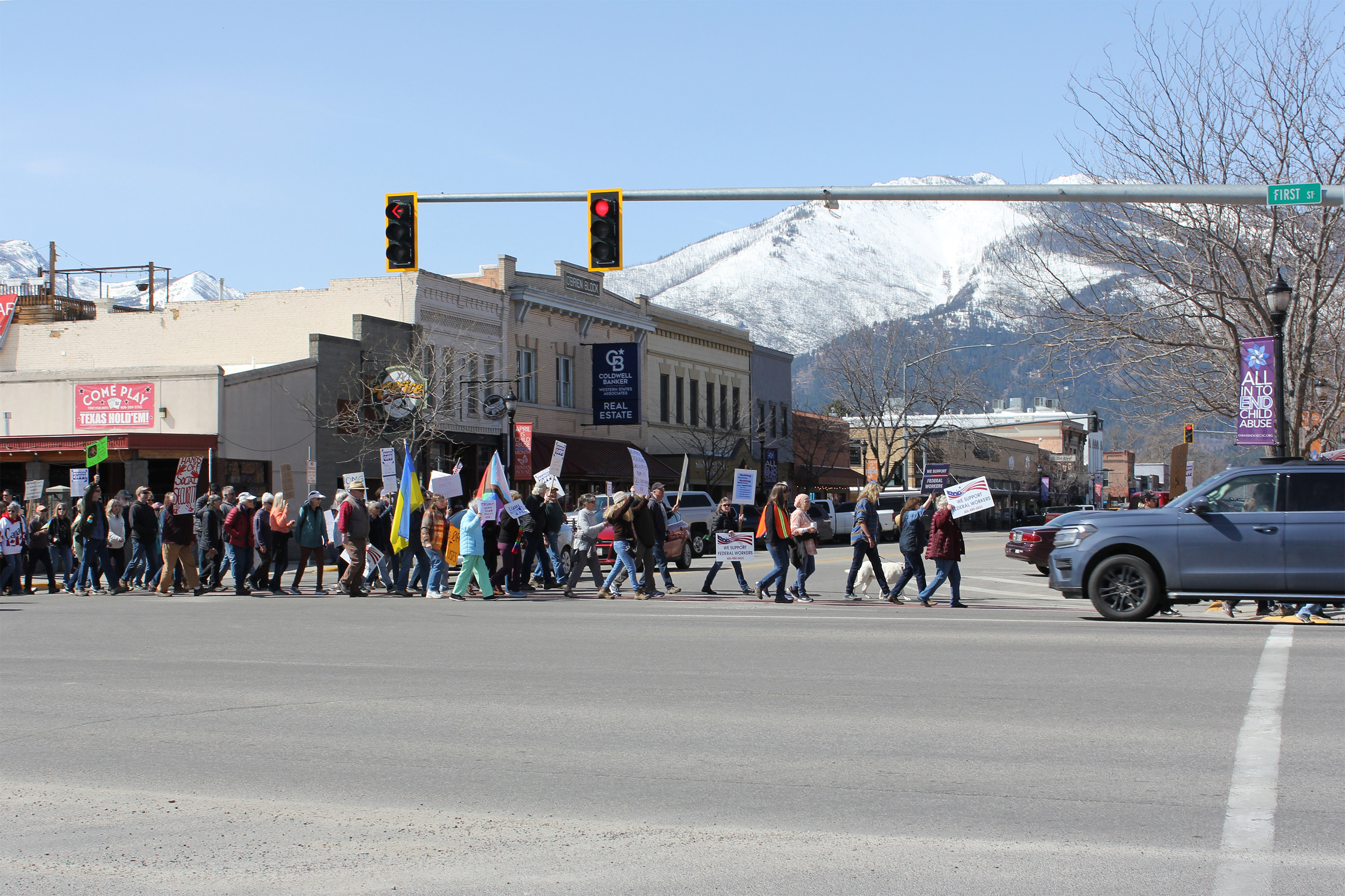 A photo of a crowd of protesters marching on street in Montana.