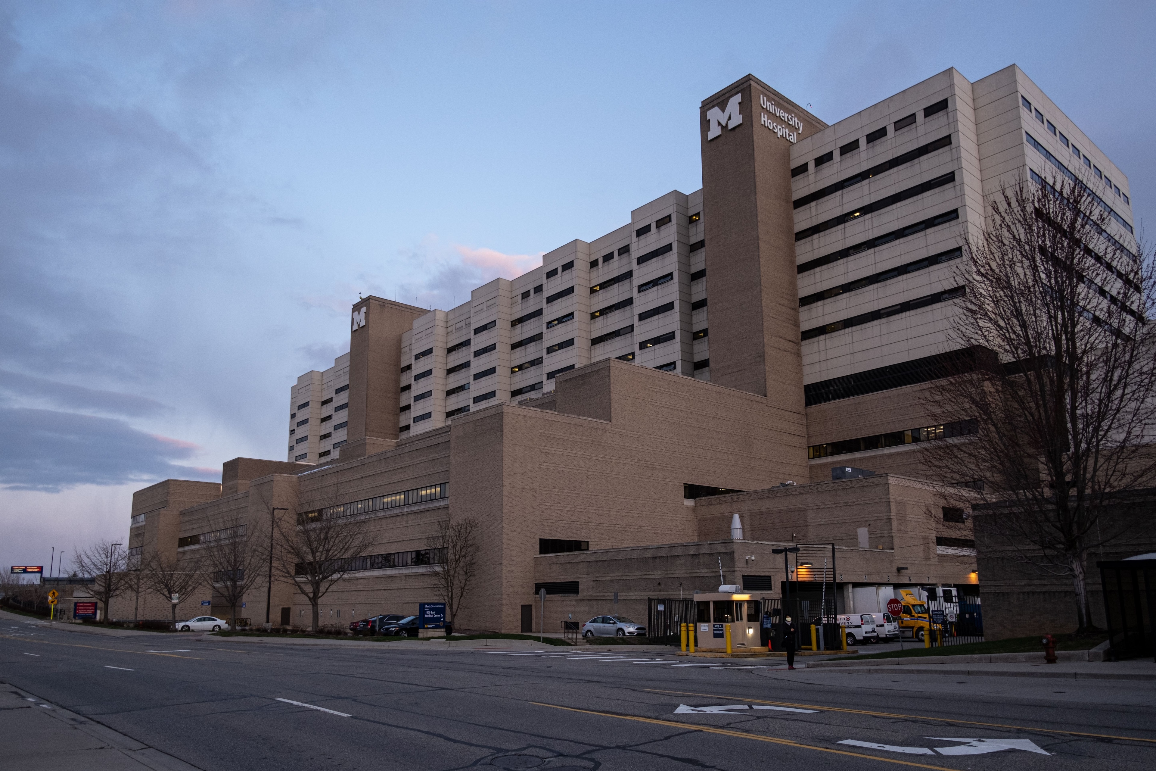 An outside view of the University of Michigan Hospital, a tan building with a large M on the outside
