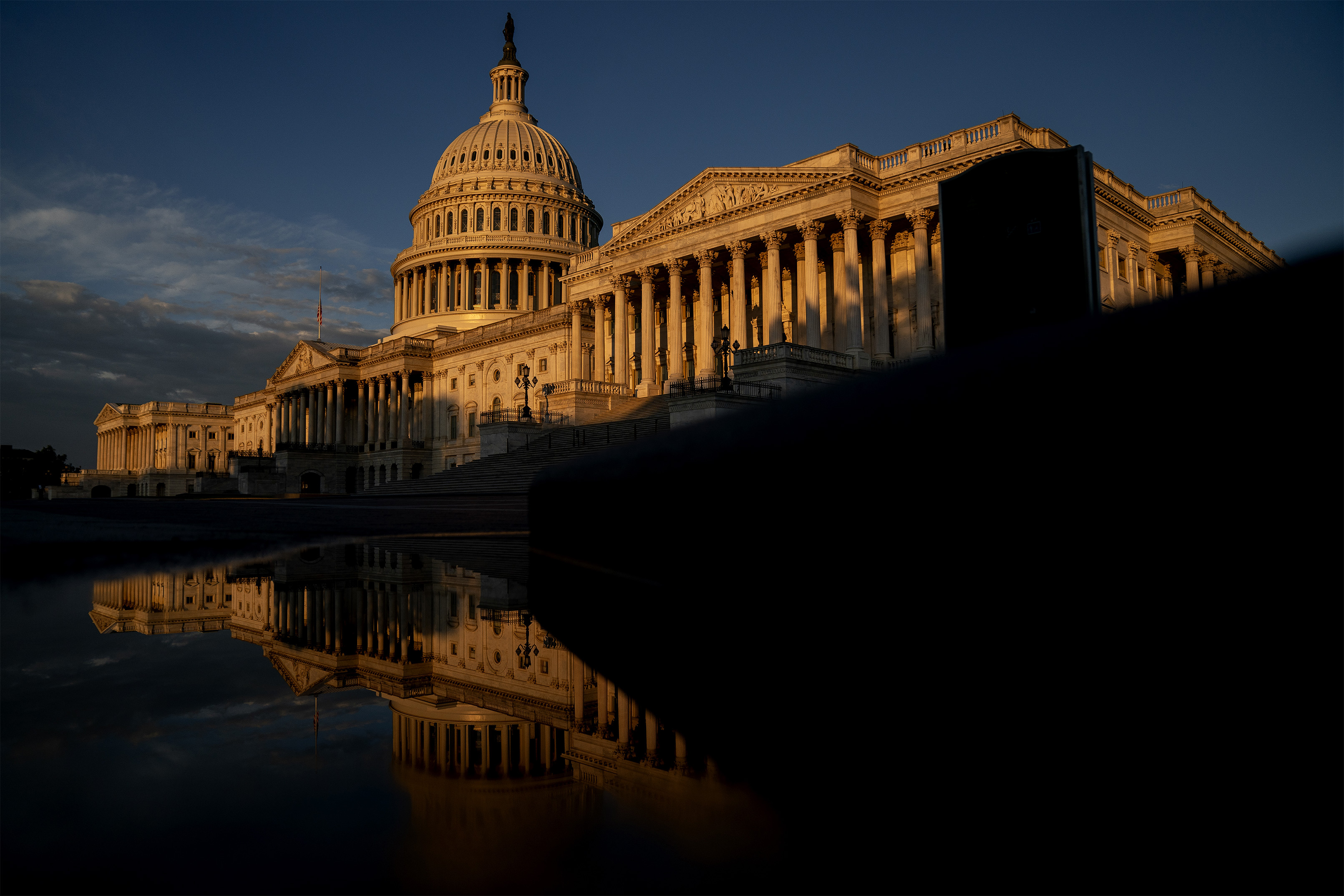 A photo of the US Capitol building at sunrise.