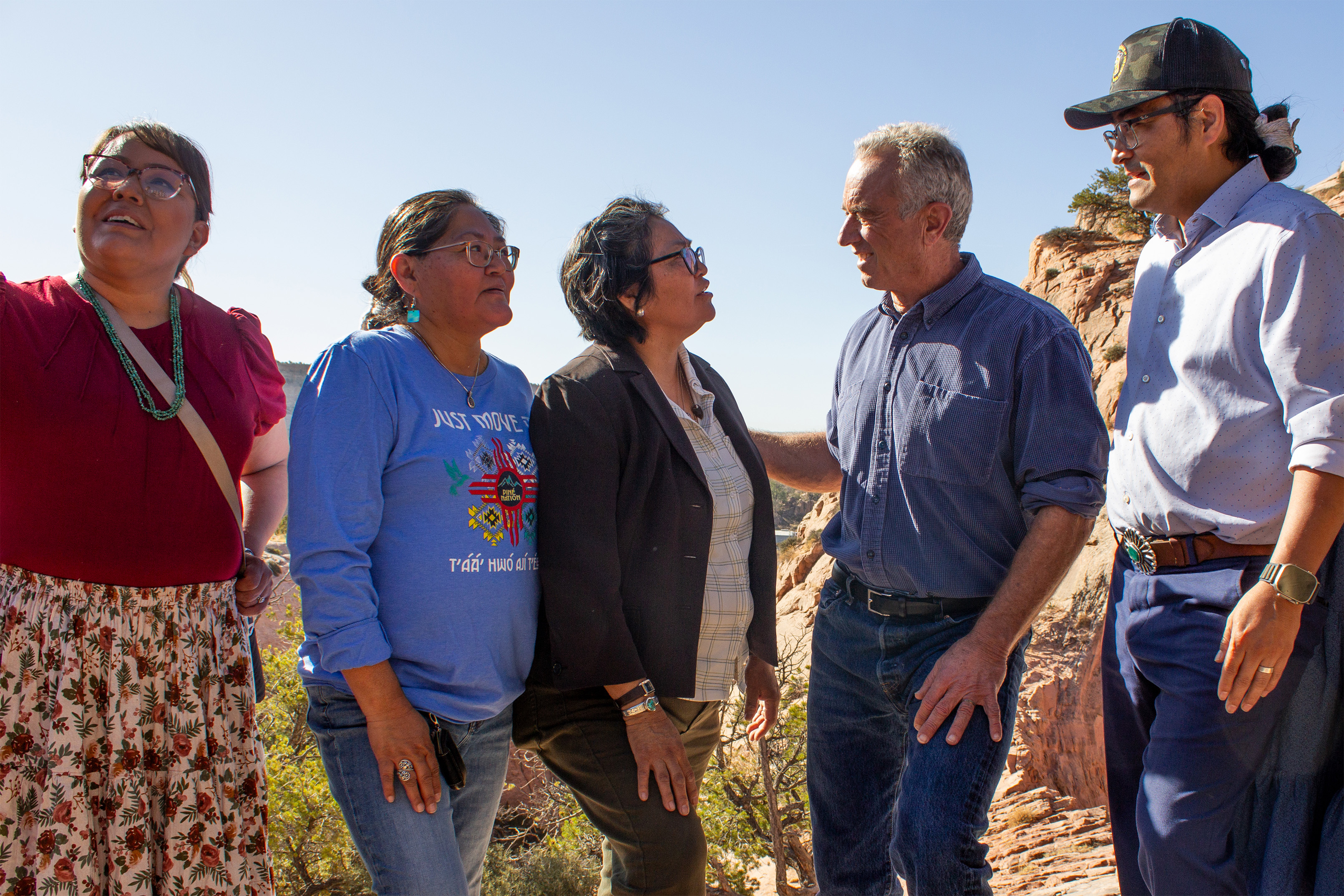 A photo of Navajo tribal members meeting with Robert F. Kennedy Jr. outside.