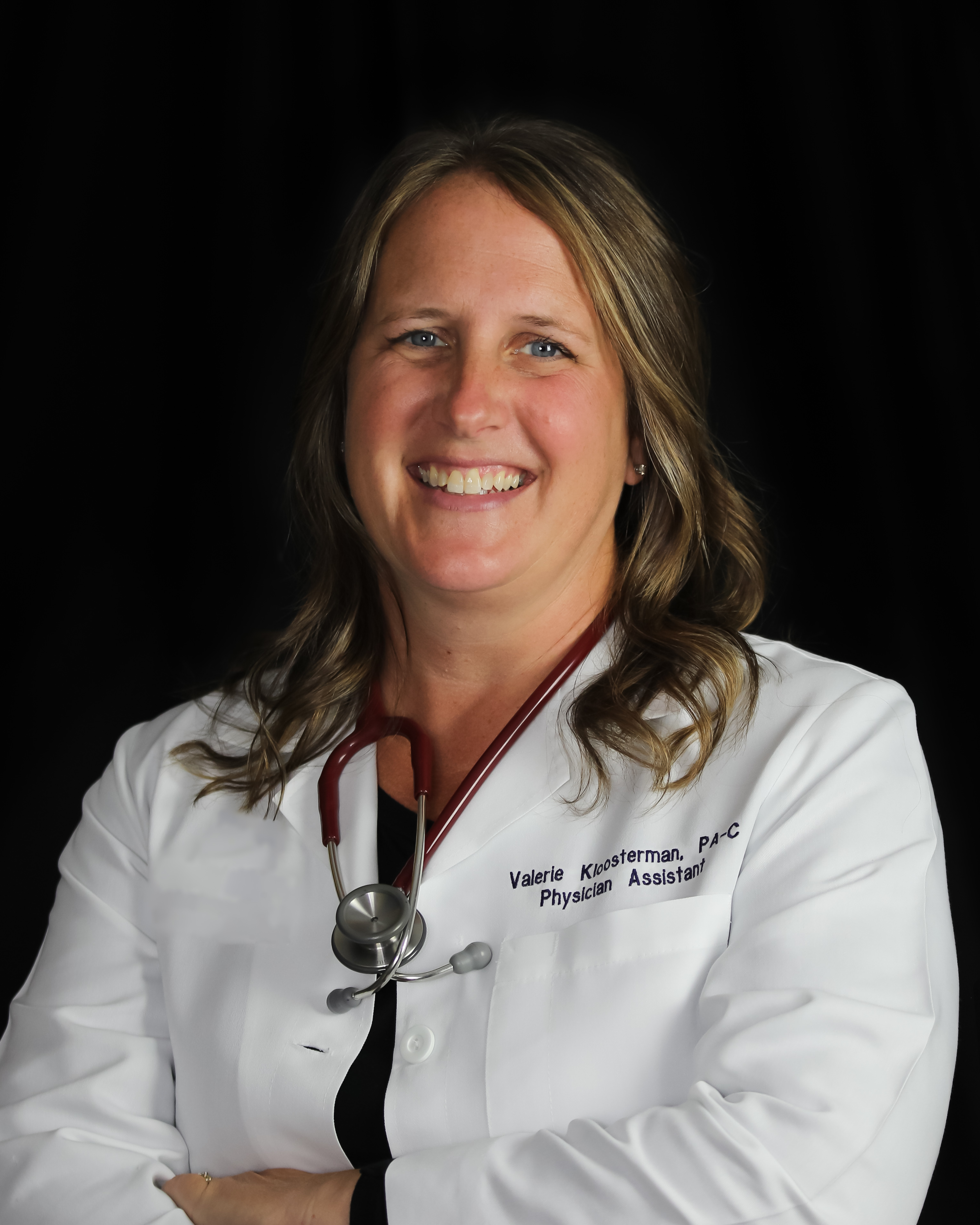 A headshot of a female physician assistant in a white coat with a stethoscope around her neck.