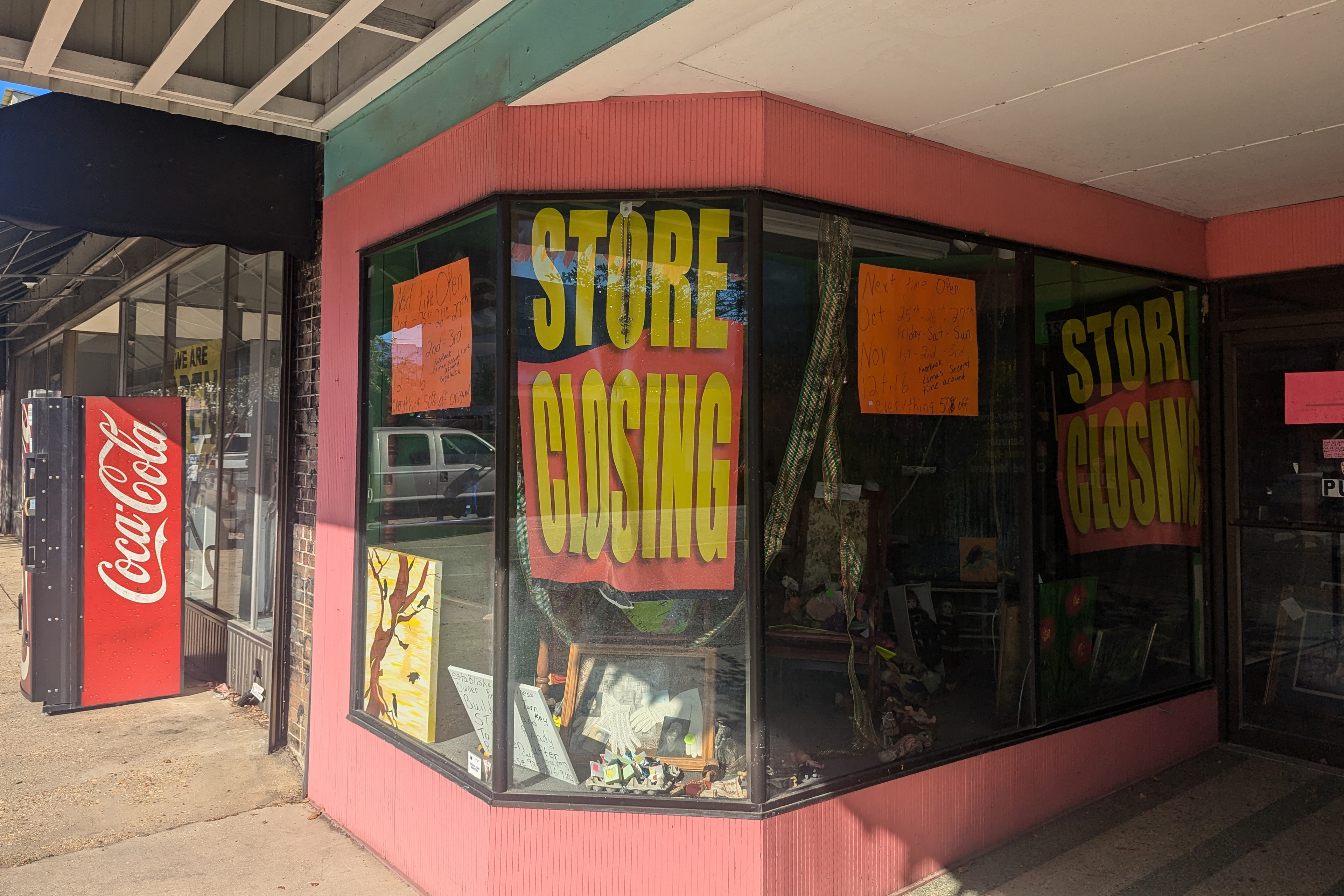 A photo of a storefront window with large "Store closing" signs.