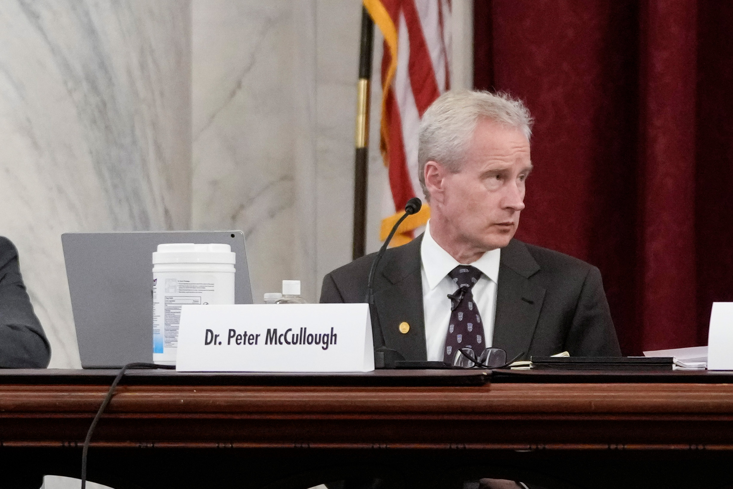 A photo of Peter McCullough seated during a panel inside the U.S. Senate.