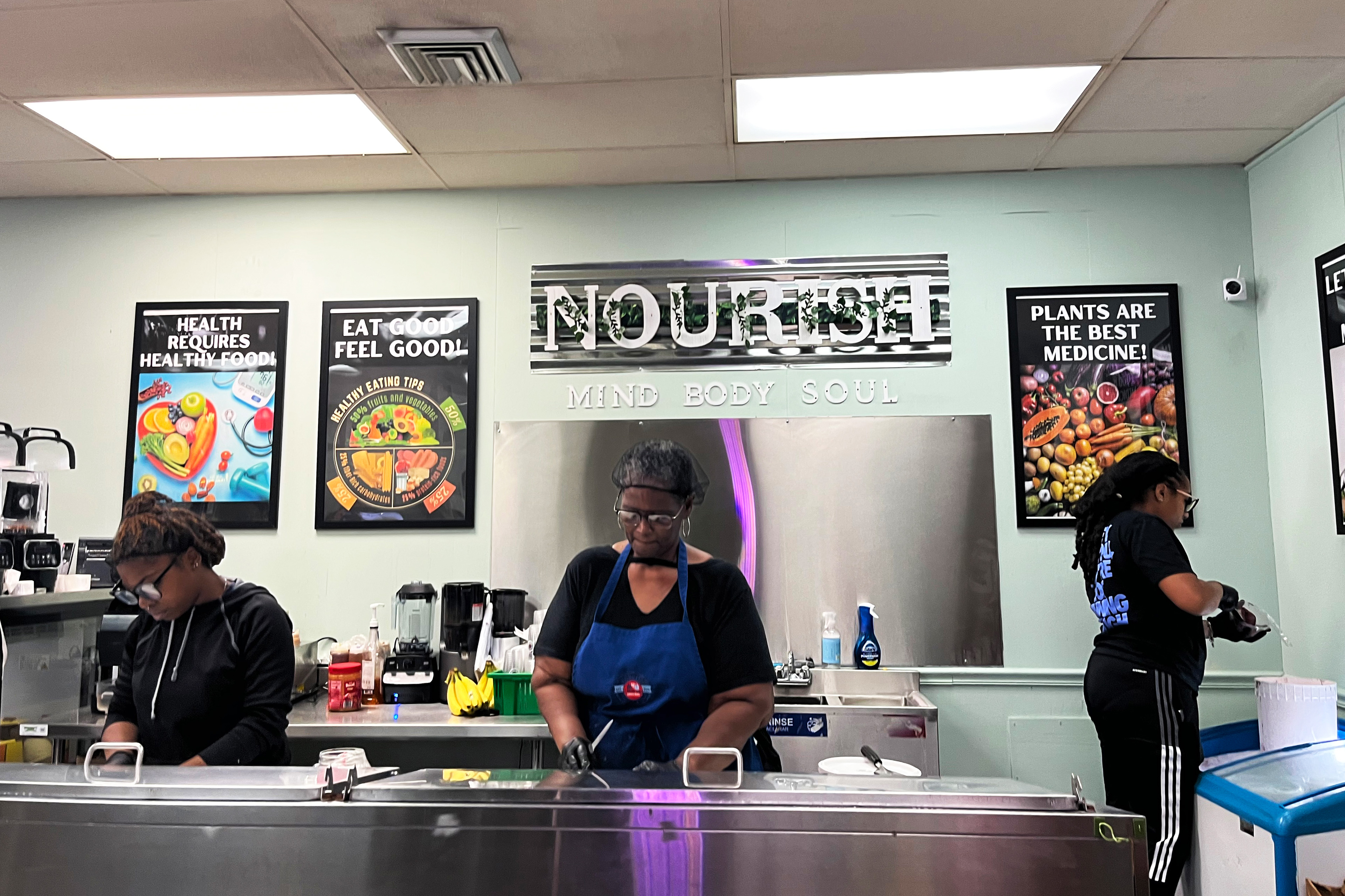 A photo of workers preparing juices and smoothies.