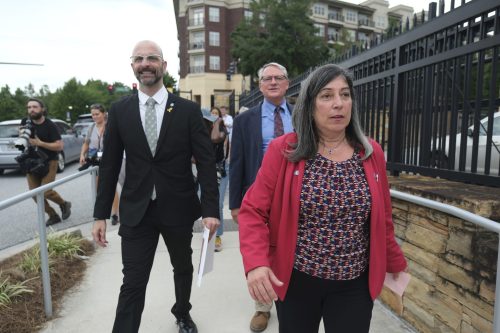 Former CDC officials Dan Jernigan Deb Houry, and Demetre Daskalakis walk out of the headquarters building.