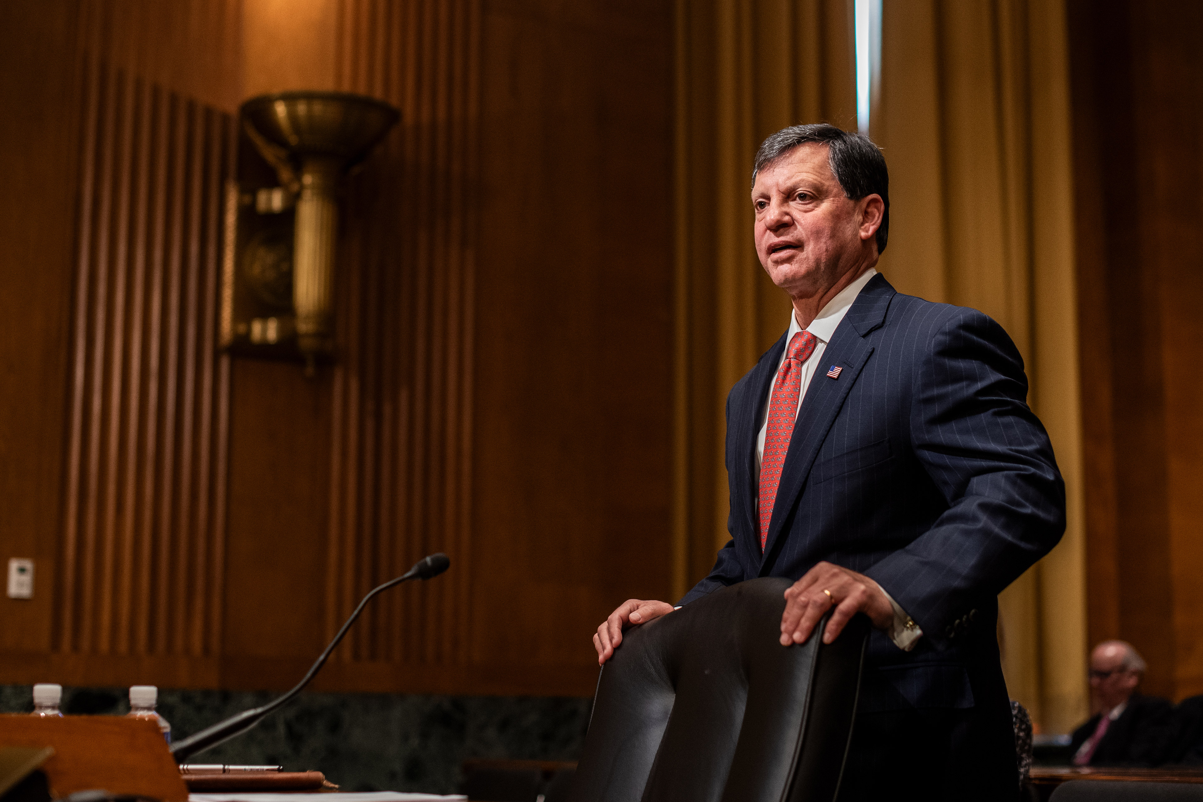 A photo of SSA chief Frank Bisignano standing in a Senate hearing room before his confirmation hearing began.