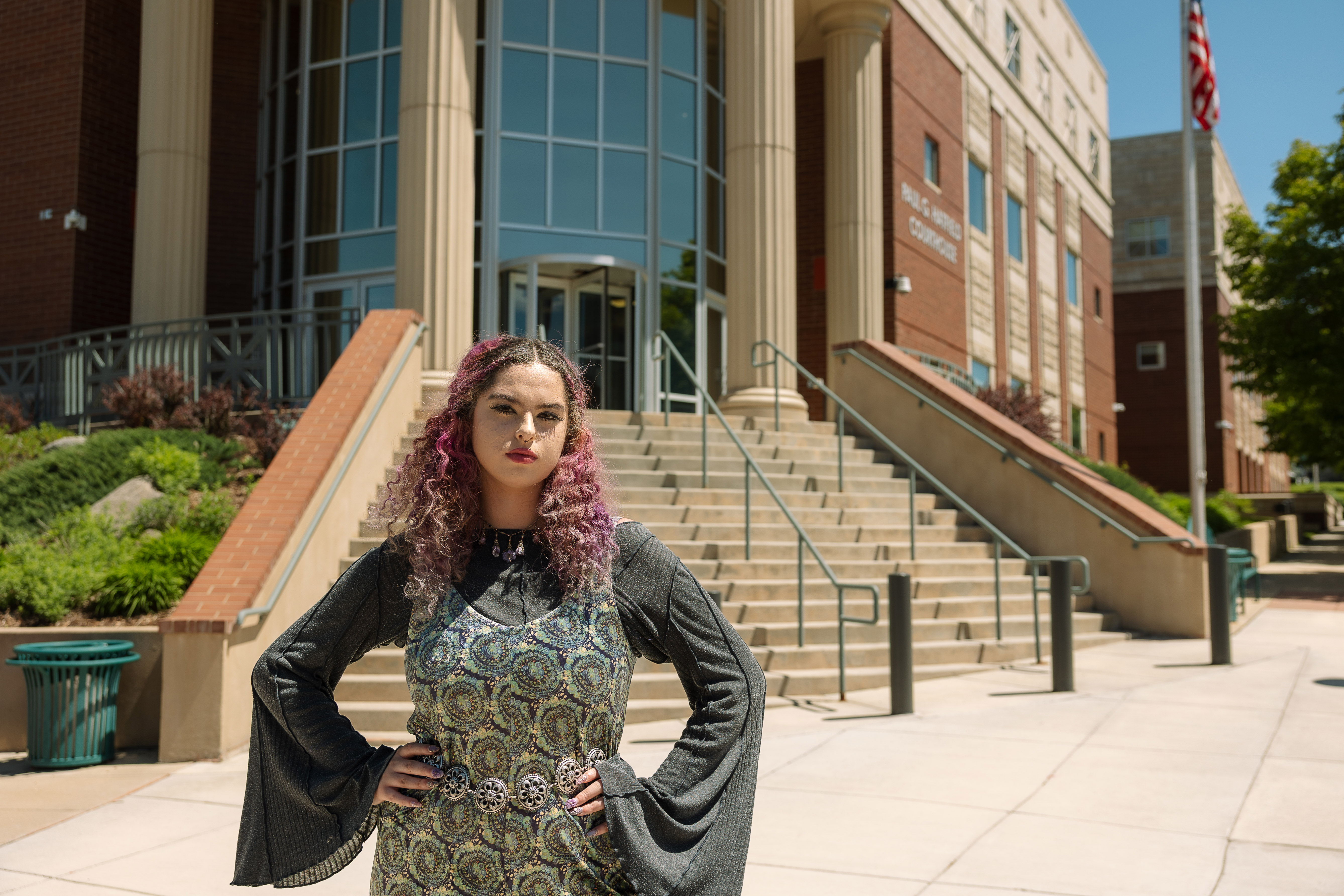 A photo of Olivia Vesovich posing in front of a courthouse.