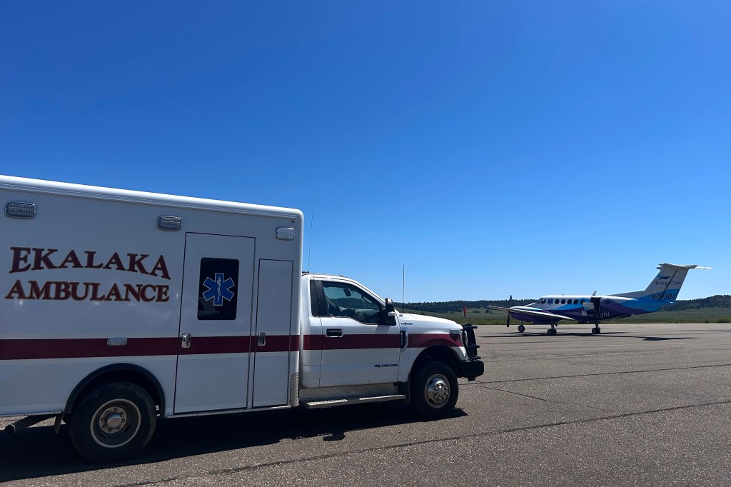 An ambulance driving along a rural road