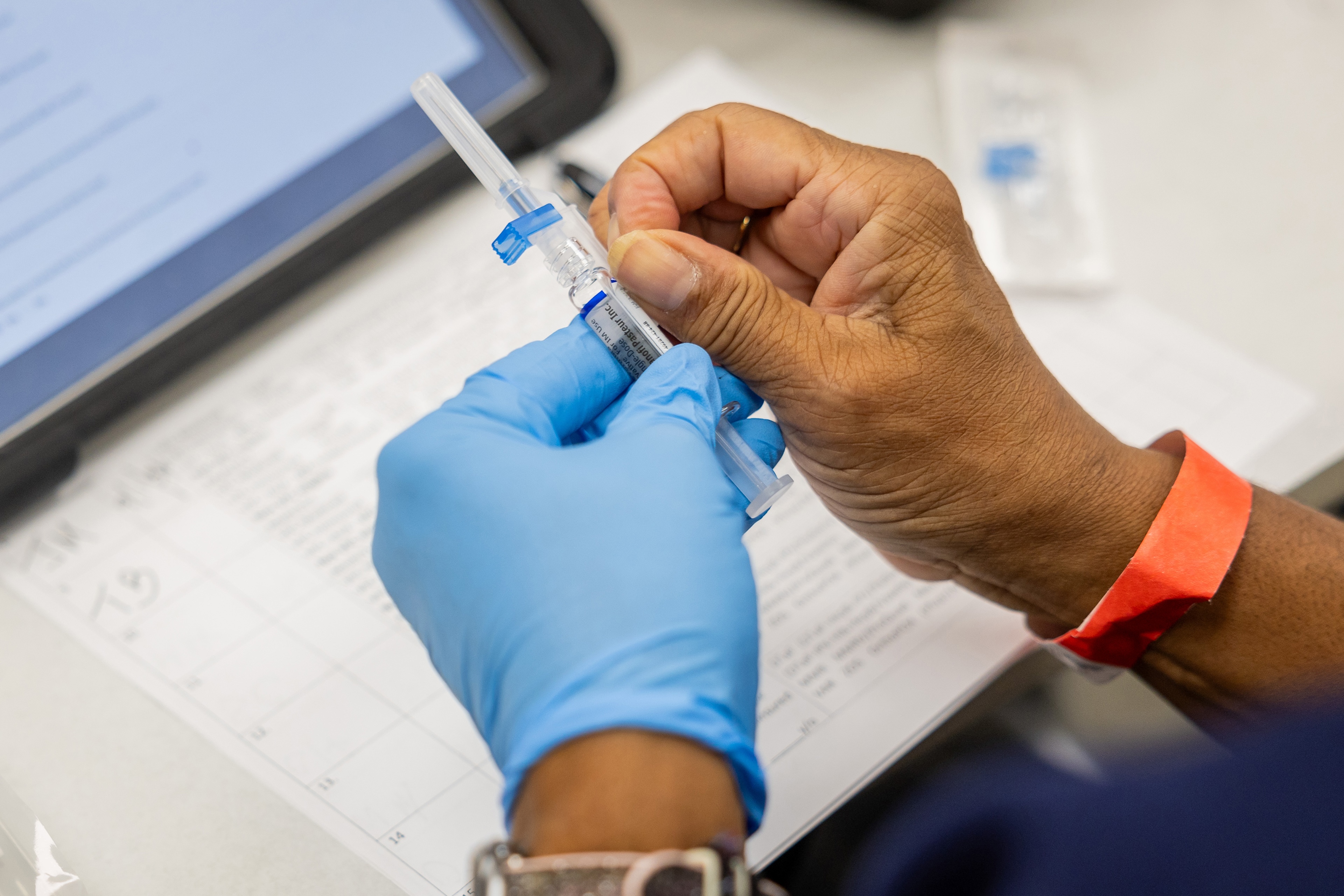A nurse prepares to administer a flu shot