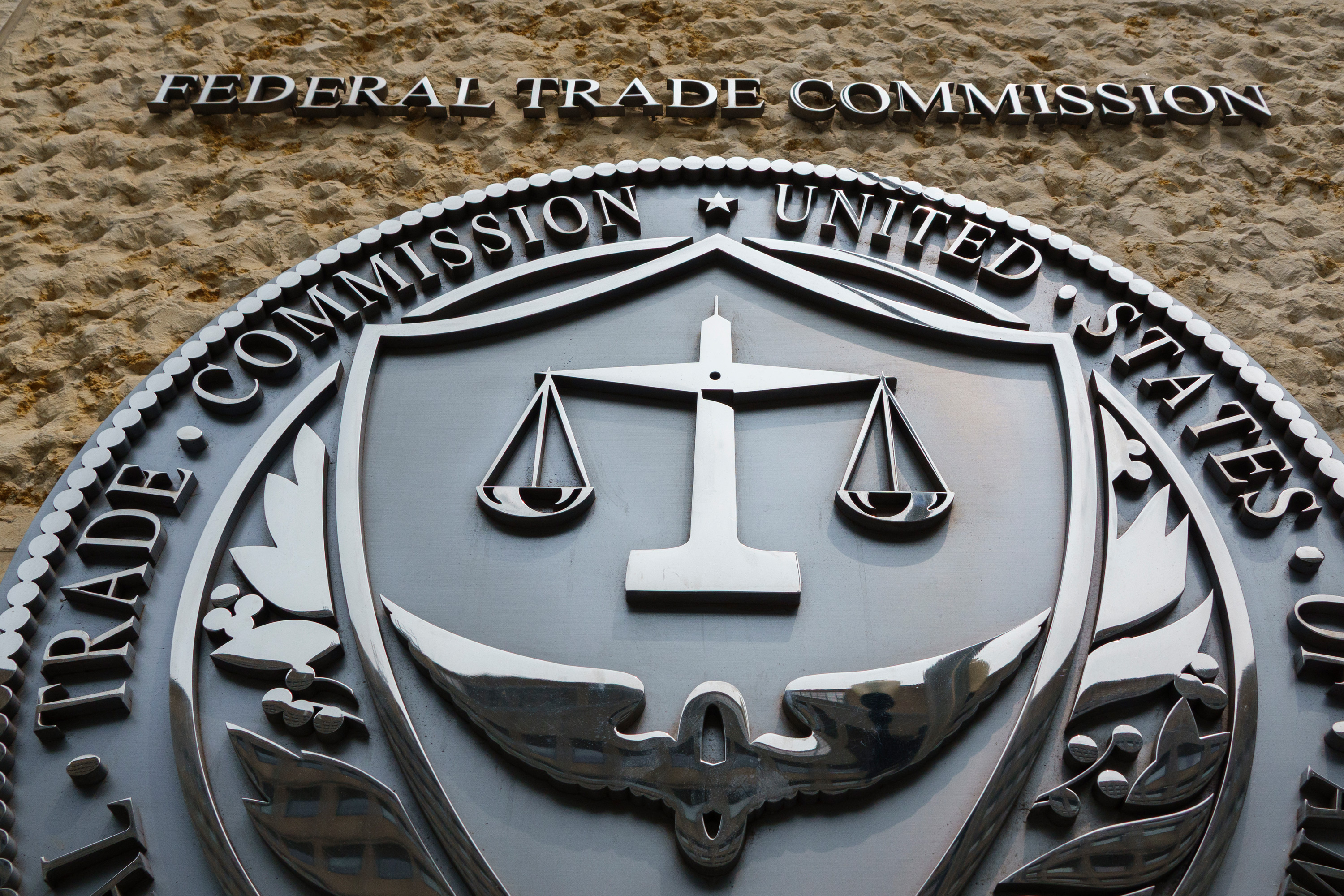 A photo of the Federal Trade Commission's logo on the outside of a building.