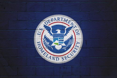 The emblem of the U.S. Department of Homeland Security is painted on a wall.
