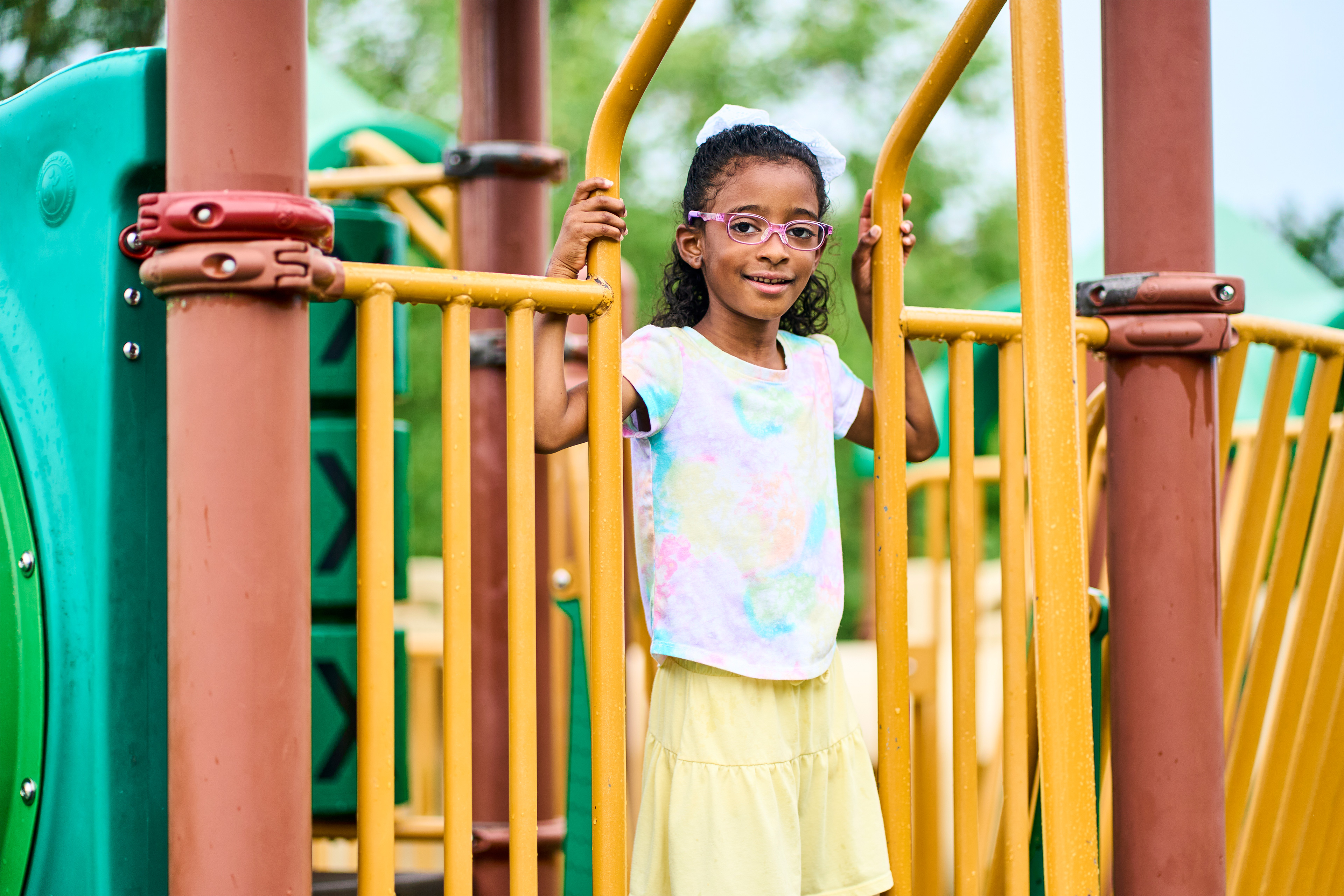 A photo of Chloë Jones standing for a photo at a playground.