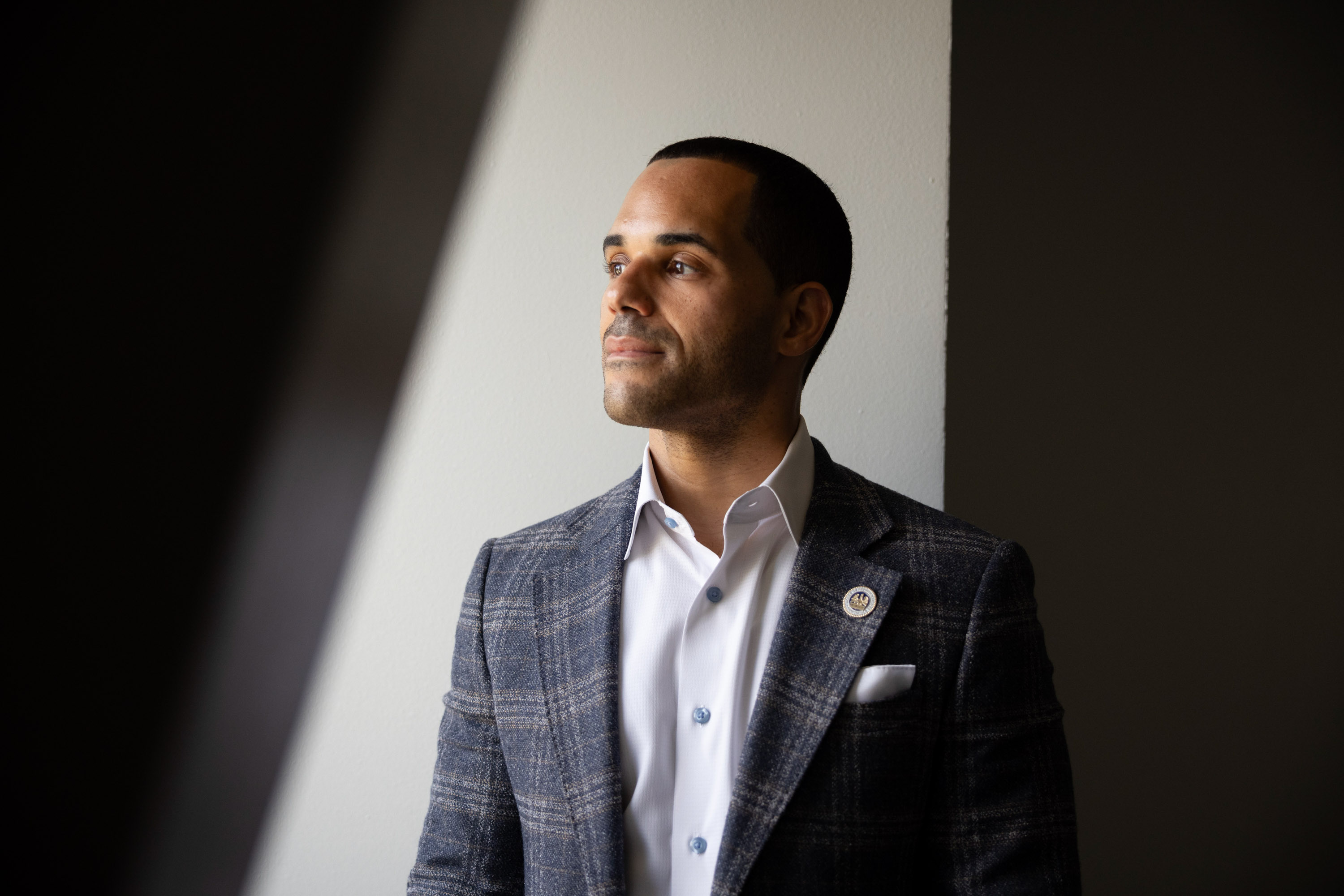 A portrait of a man in a suit indoors.