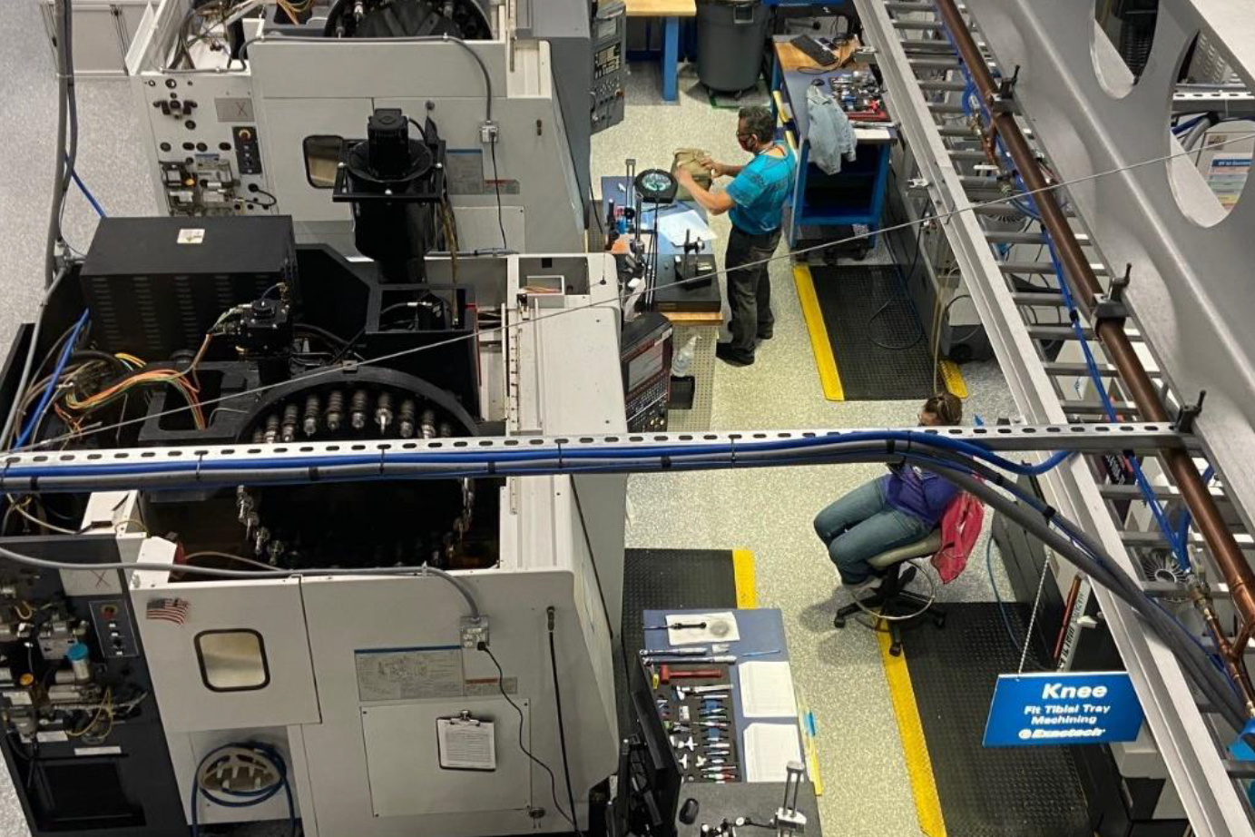 A photo of a factory floor with workers.