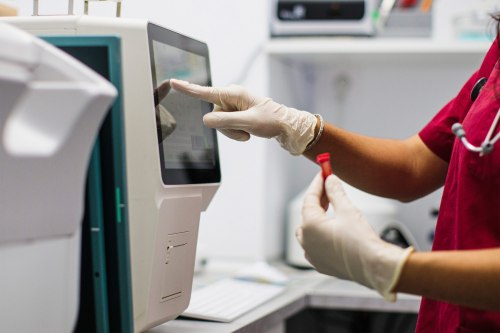 A photo of a health technician running a blood test.