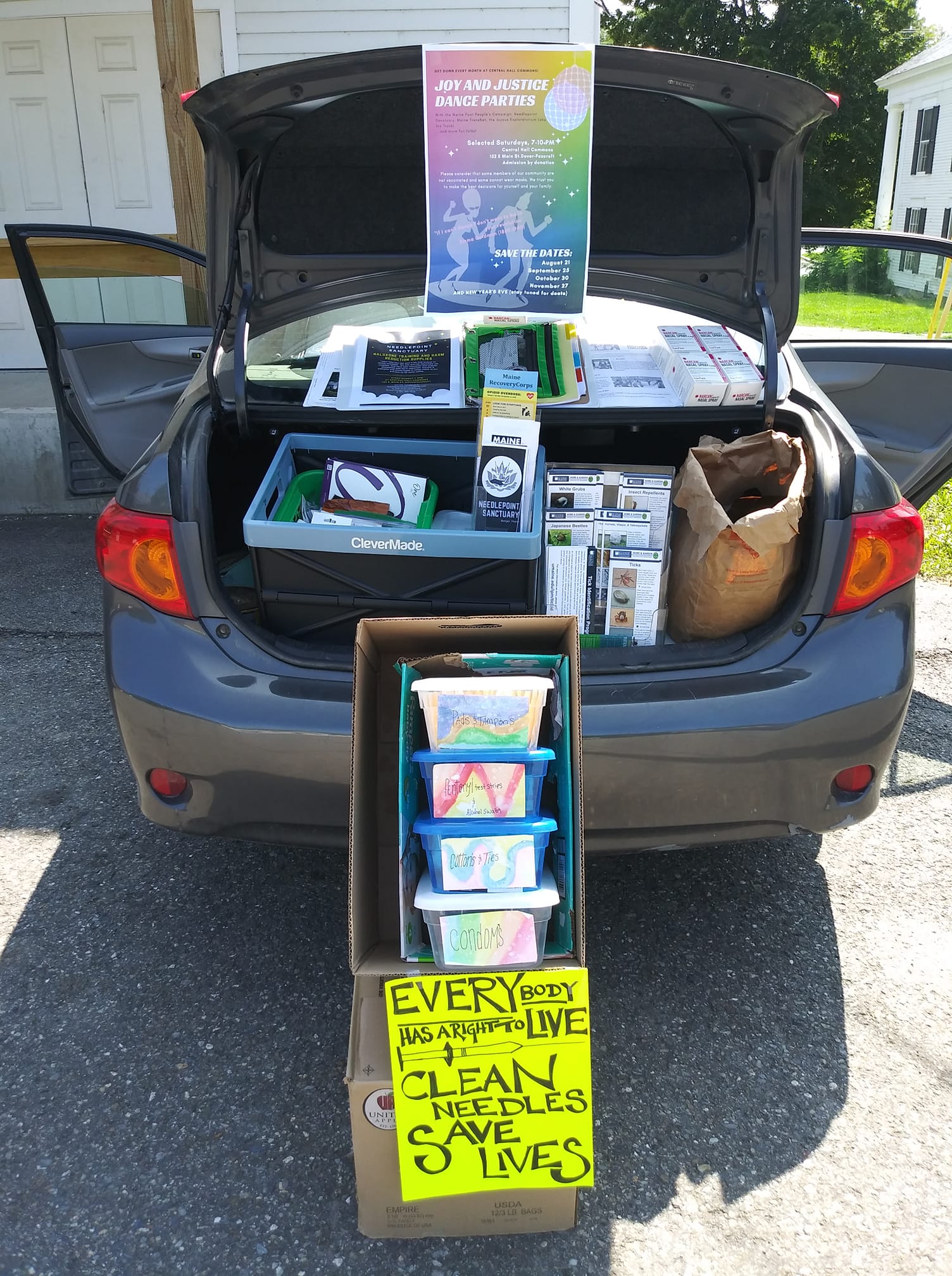 A photo of a syringe services operation being run out of the trunk of a car.