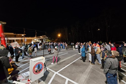 A photo at night of demonstrators outside a city hall in Maine.