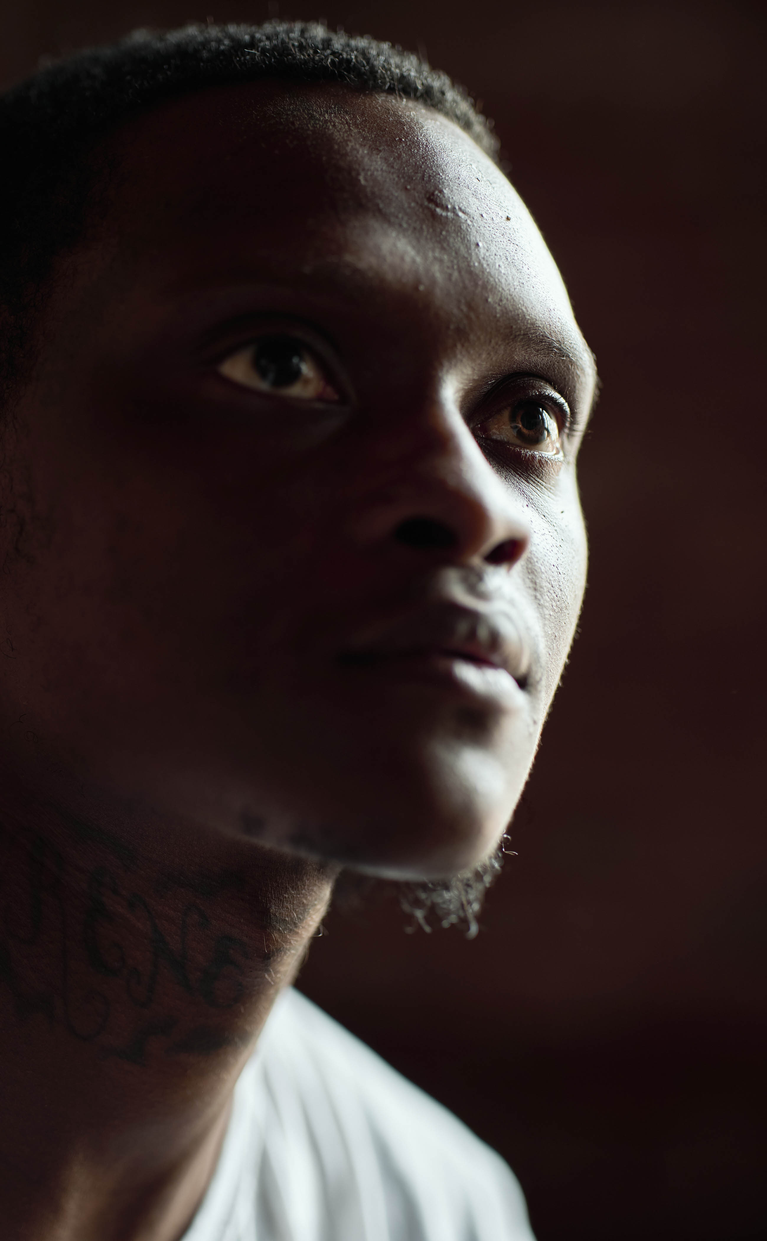 Close shot of a man's face, his eyes gazing away from the camera