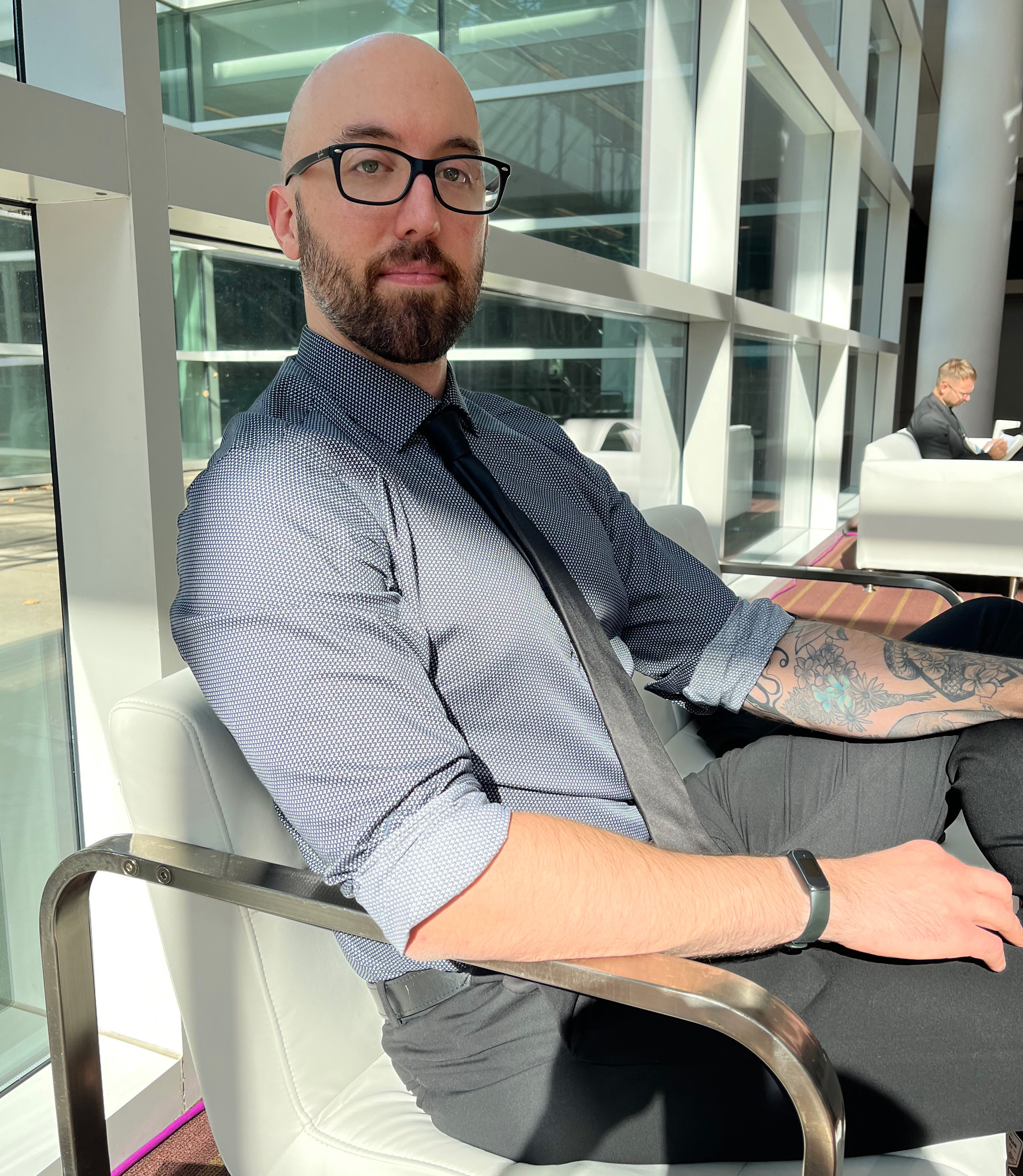 A photo of a man sitting indoors.