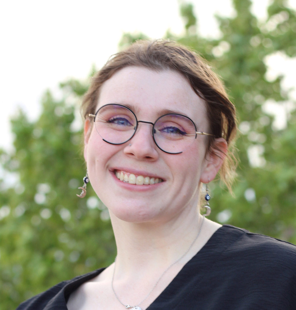 A photo of a woman smiling outside.