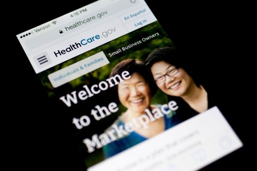 A photo of a phone screen showing the HealthCare.gov website.