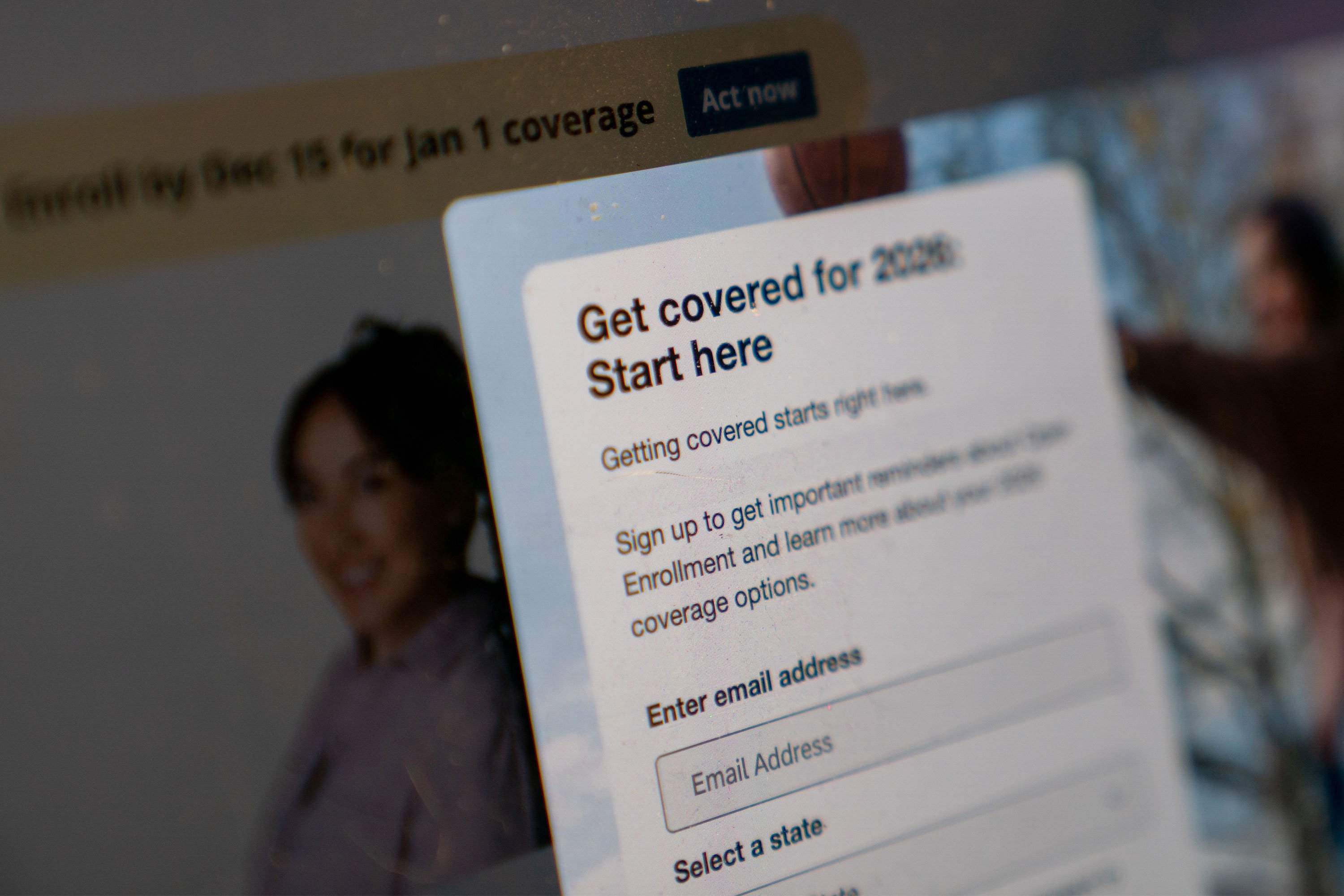 A photo of HealthCare.gov's website. A pop-up form reads, "Get covered for 2026. Start here."