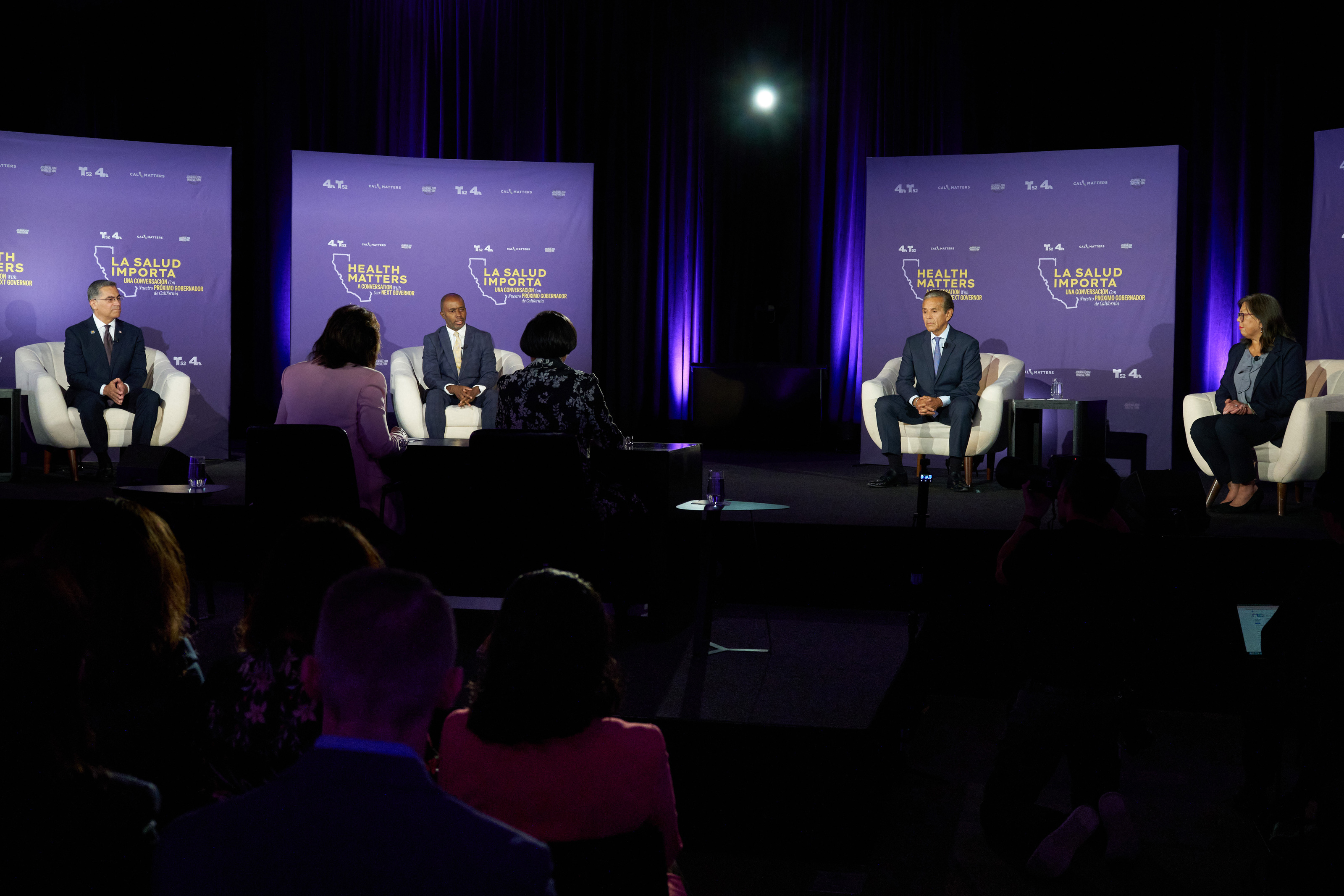 Four people sit on a stage: (from left) former U.S. Health and Human Services Secretary Xavier Becerra, California Superintendent of Public Instruction Tony Thurmond, former Los Angeles Mayor Antonio Villaraigosa, and former state Controller Betty Yee.