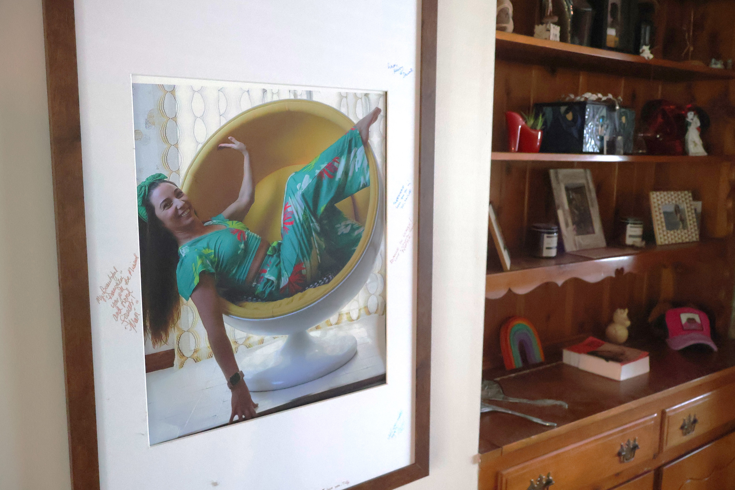 A photo of Erika "Tilly" Edwards posing in a chair.