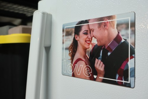 A photo of a husband and wife on a refrigerator magnet.