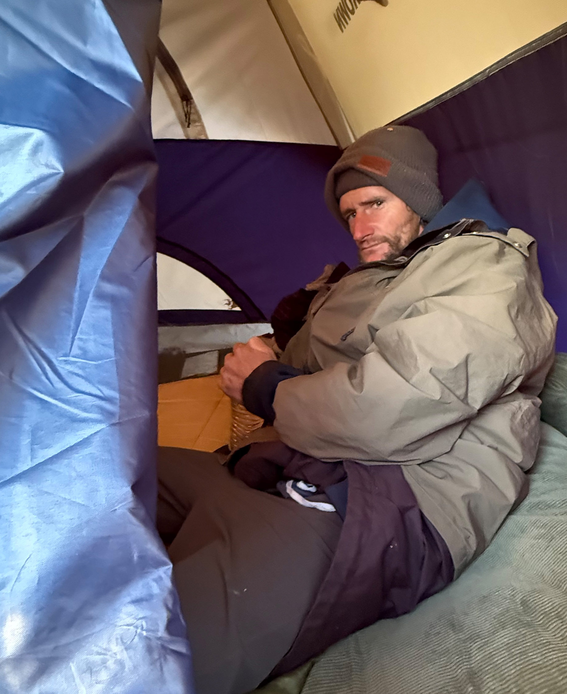 A photo of a homeless man in his tent.