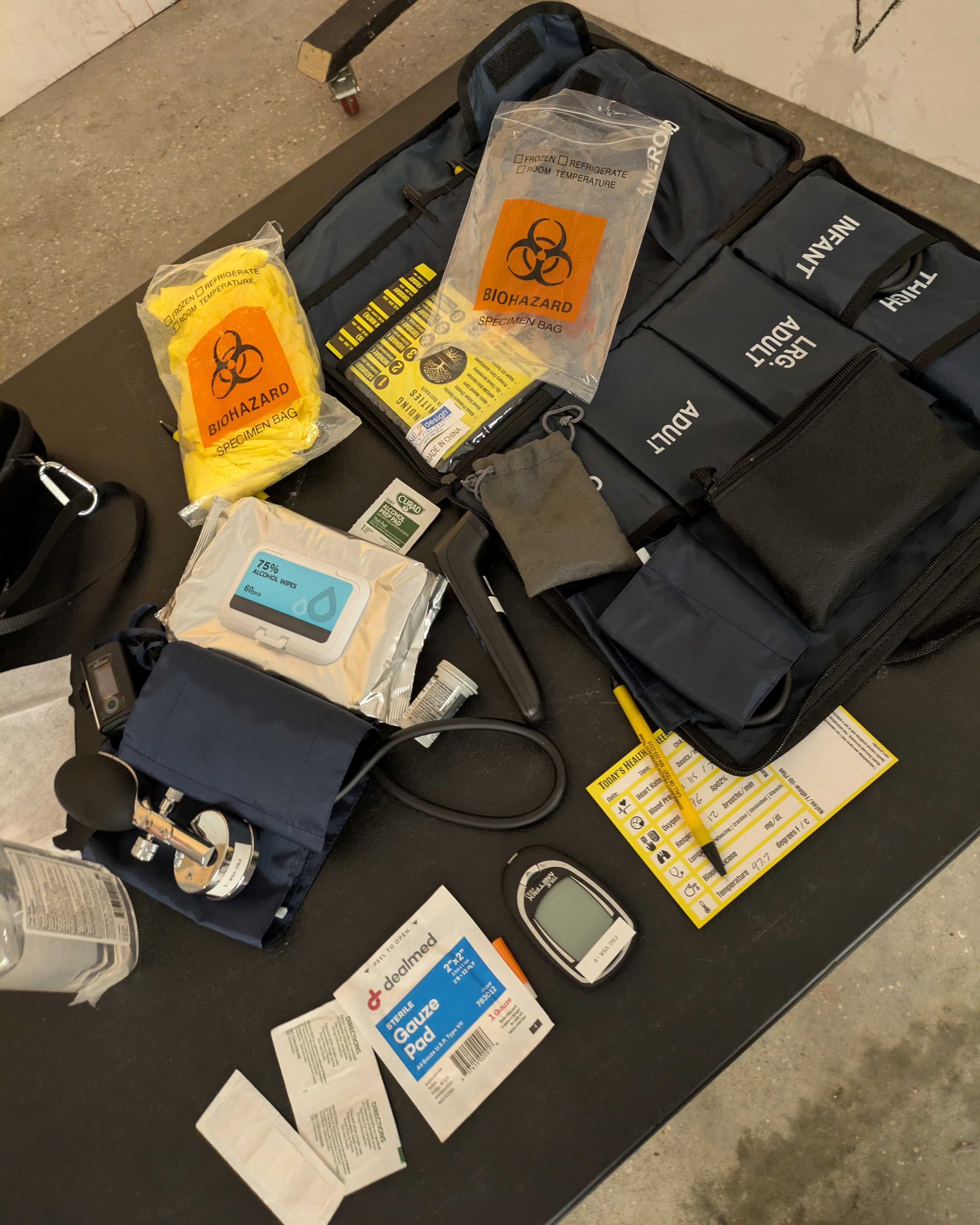 A photo of alcohol wipes, gauze pads, and biohazard bags on a table.