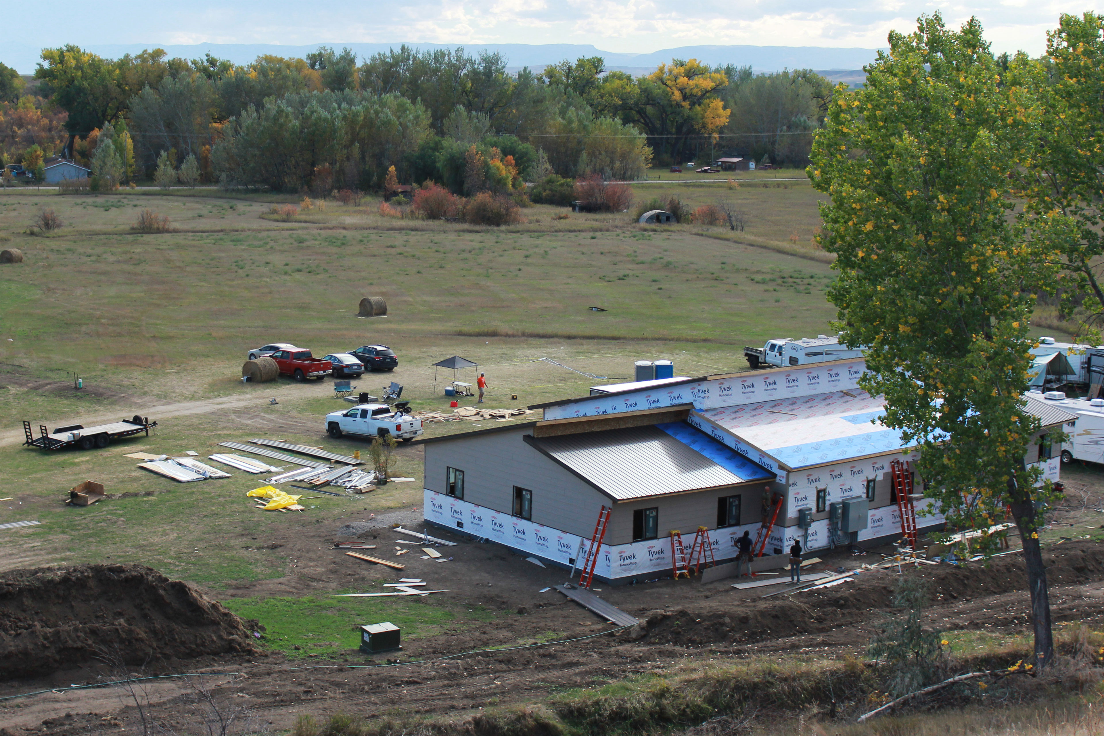 The view from a hill looking down at a building under construction.