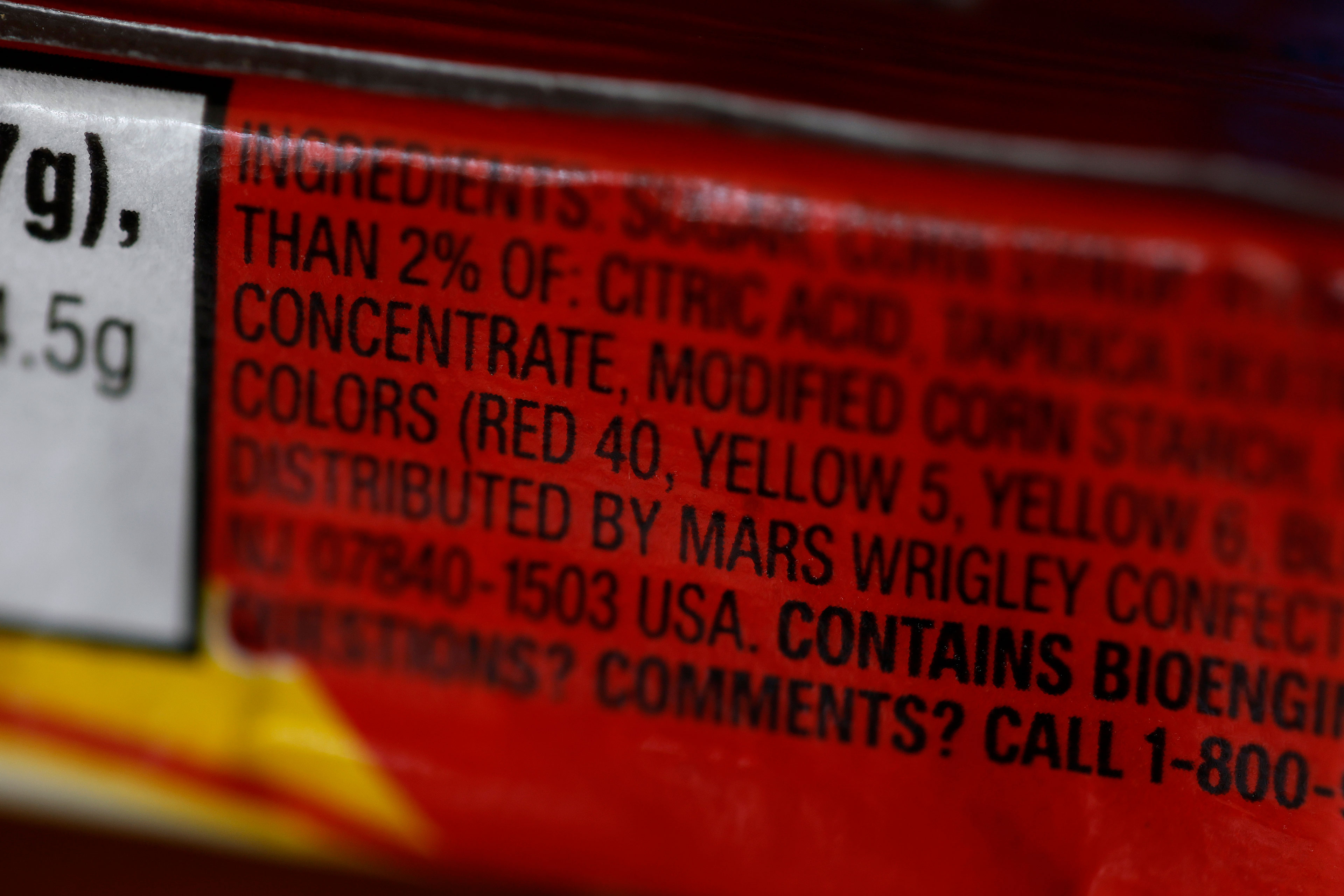 A photo zoomed in close-up on an ingredients list. The focus is on a list of food dyes.