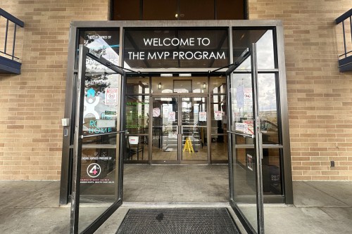 A photo of an open glass doorway. Writing on the top of the doorway reads, "Welcome to the MVP Program."
