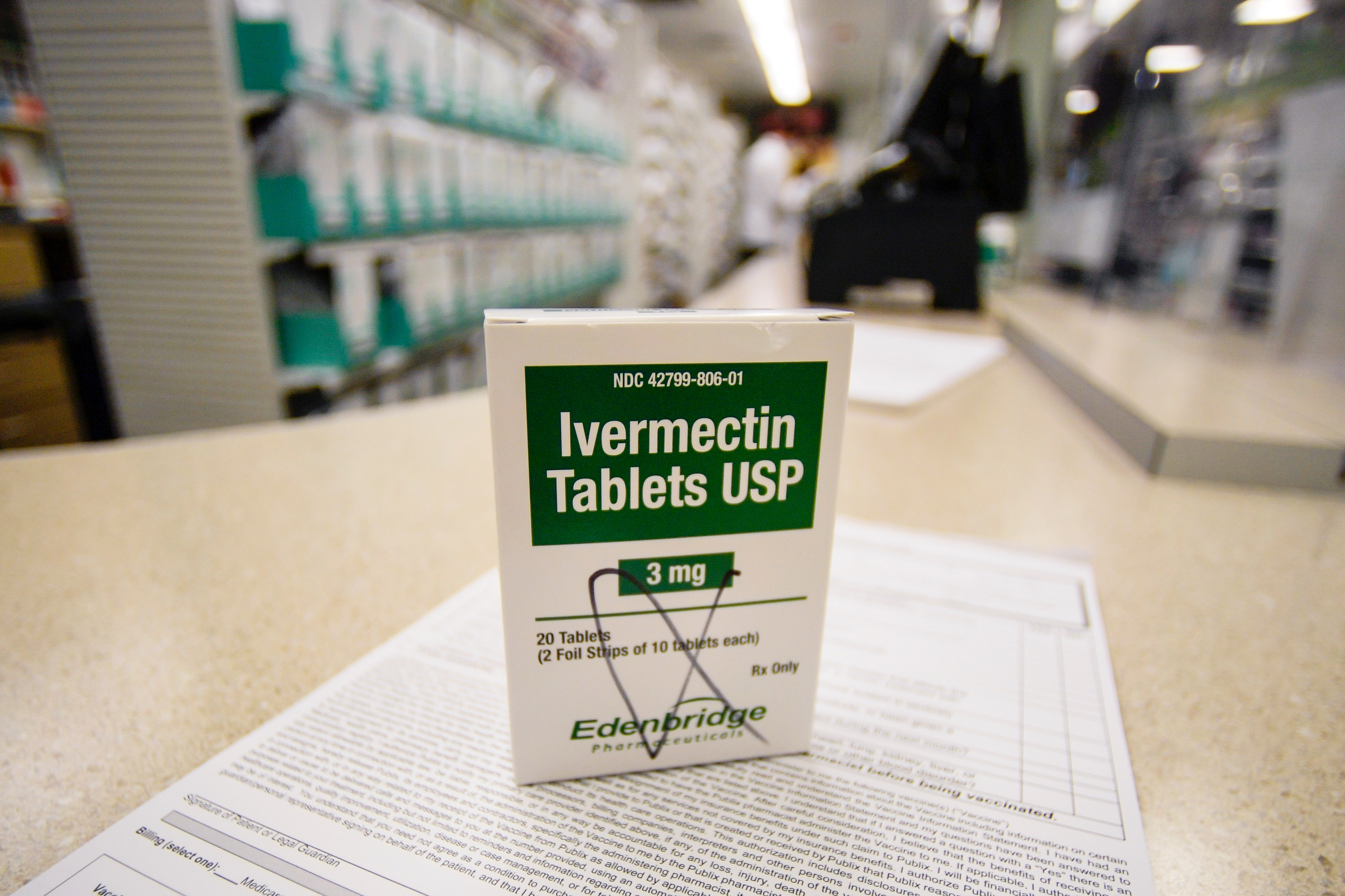 A box of ivermectin tablets is shown in a pharmacy.