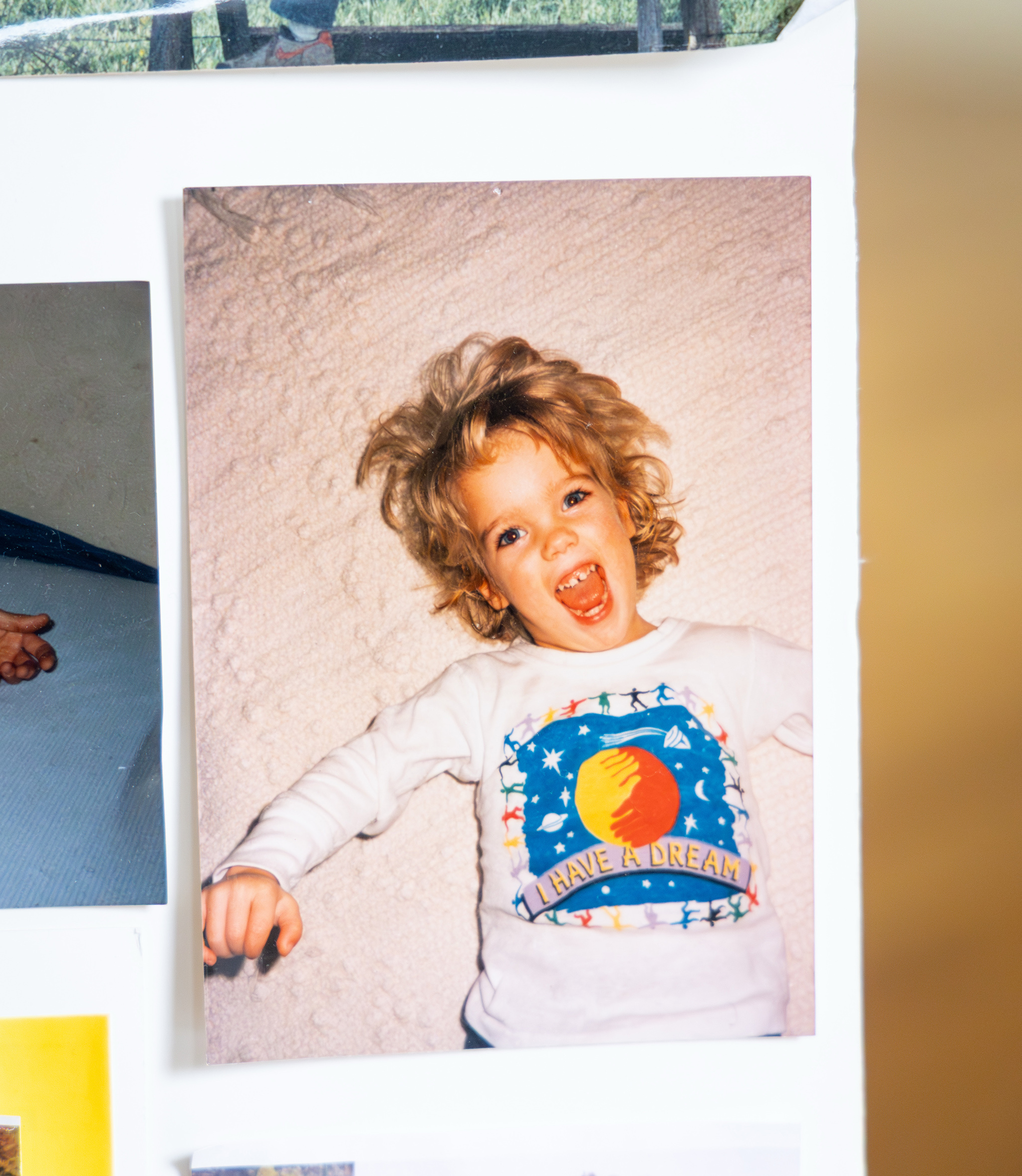 A photograph of a picture of a young girl lying down and smiling