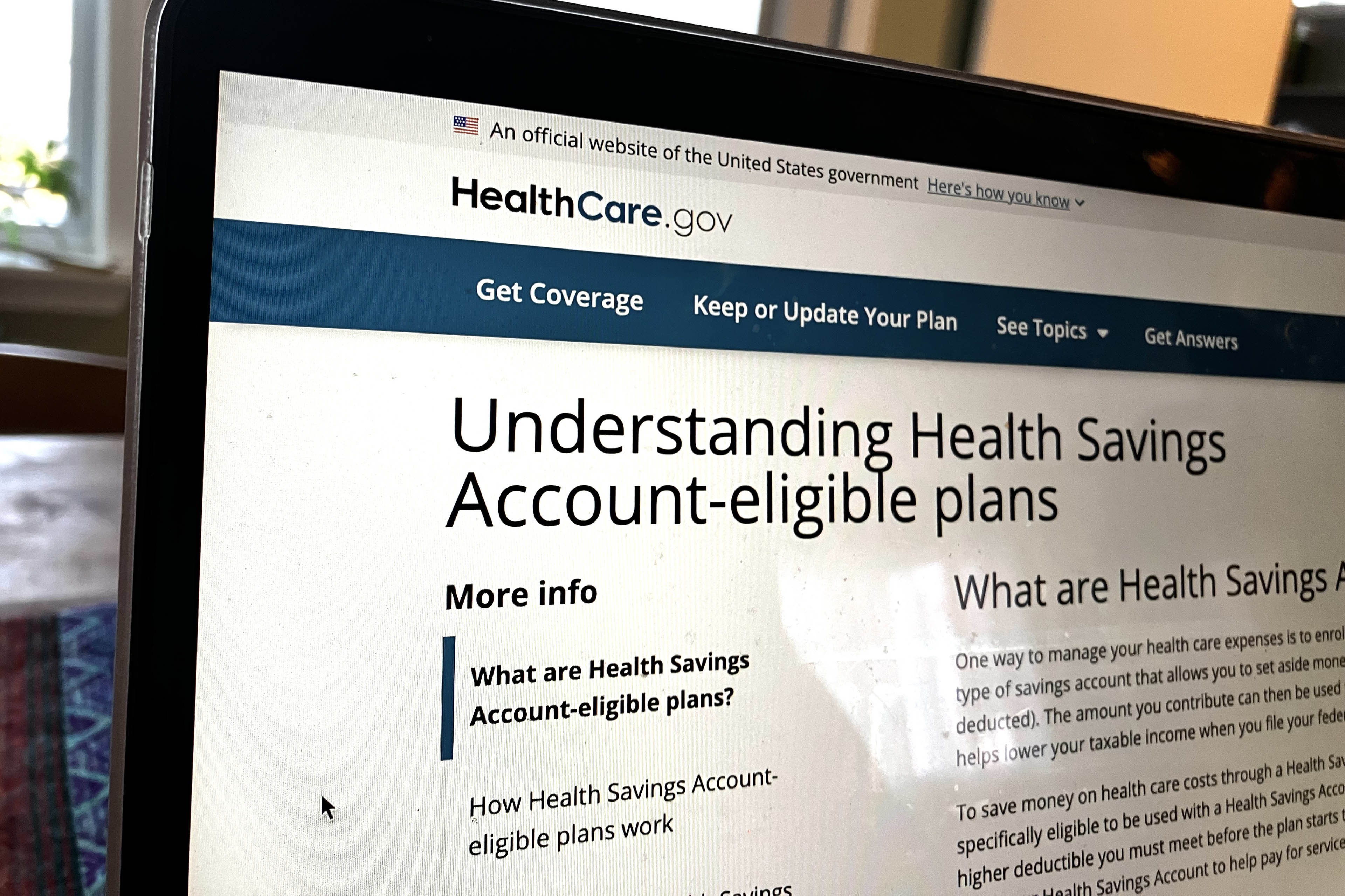 A photo of the healthcare.gov website on a laptop, which shows a page with information about HSAs.