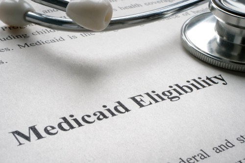 A document with Medicaid eligibility and stethoscope.