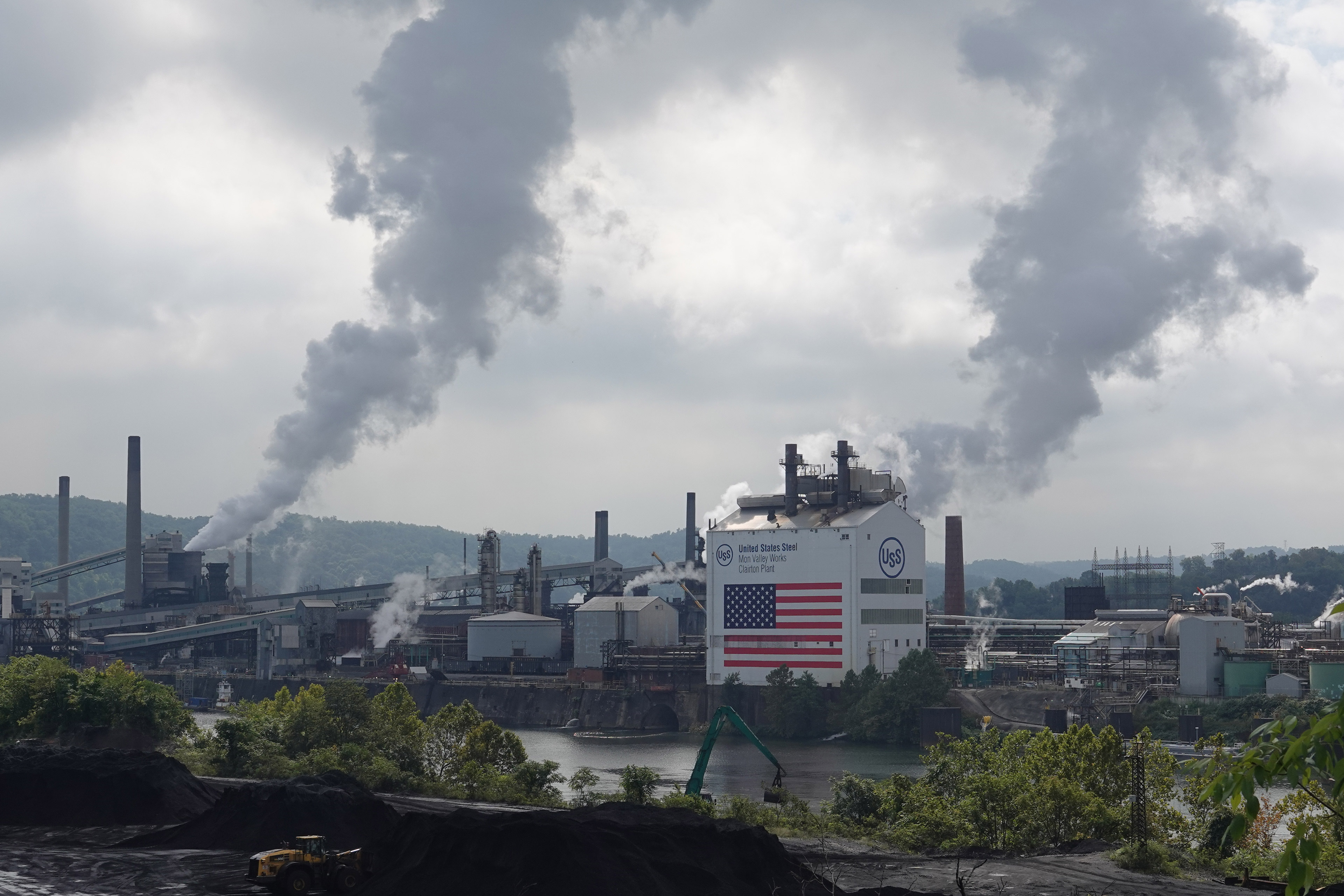 A view of the Clairton Plant and Clairton Coke Works facilities along the Monongahela River. Smog billows out of smokestacks from both facilities.