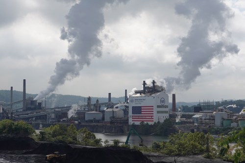 A view of the Clairton Plant and Clairton Coke Works facilities along the Monongahela River. Smog billows out of smokestacks from both facilities.