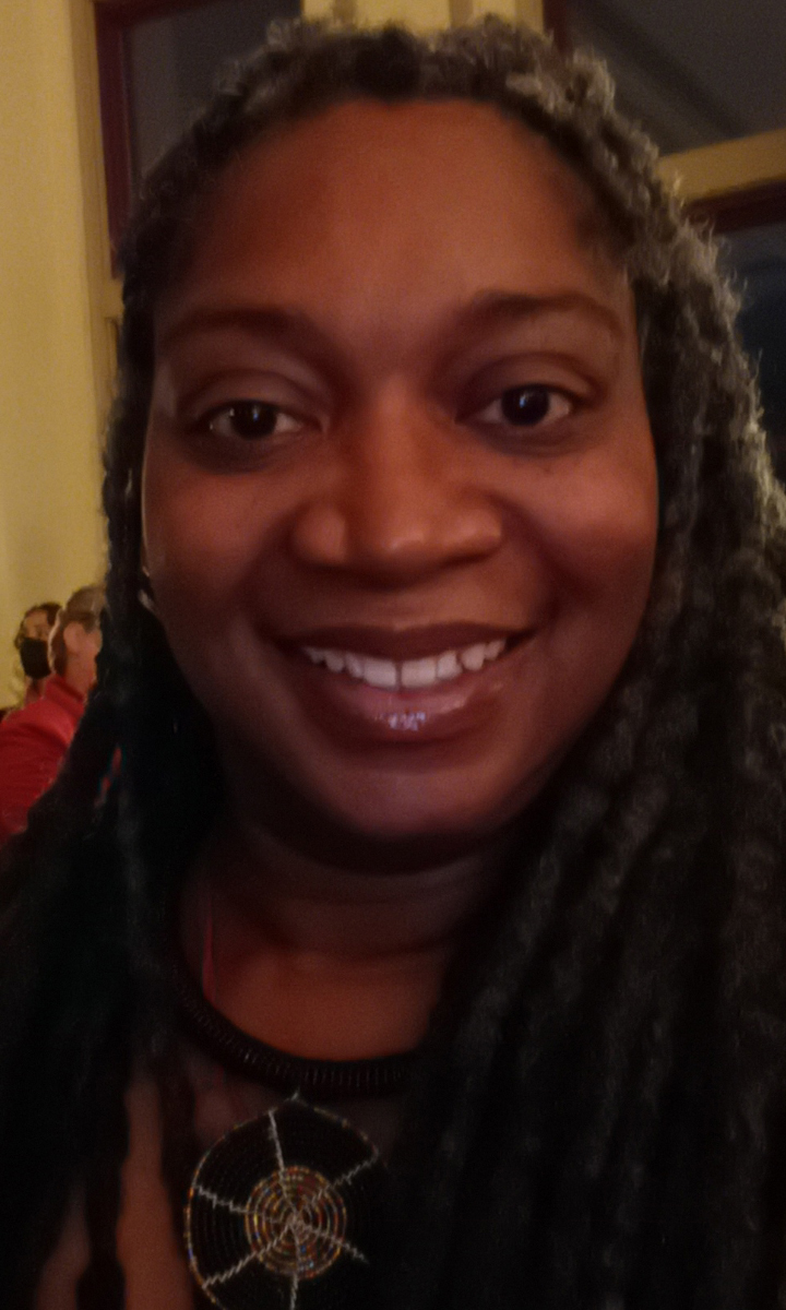 A close-up selfie of a woman smiling