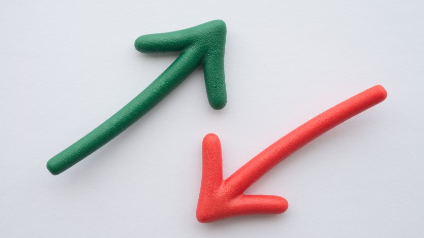 A green arrow points up beside a red arrow that points down on a white background.