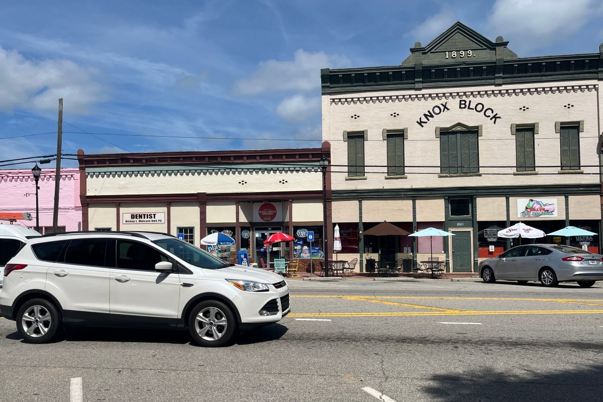 A strip of old, two-story buildings in a small town.