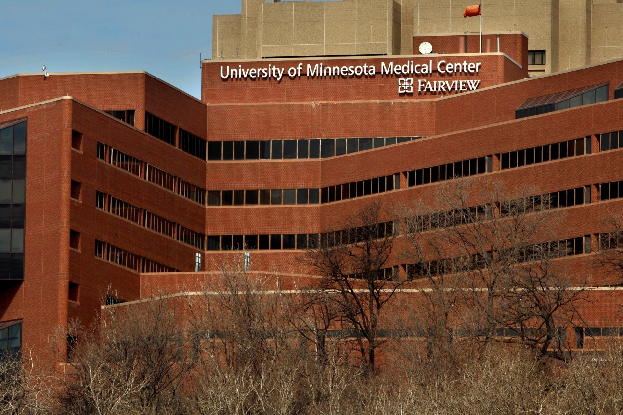 A large brick building with large white letters at its top reading "University of Minnesota Medical Center Fairview"